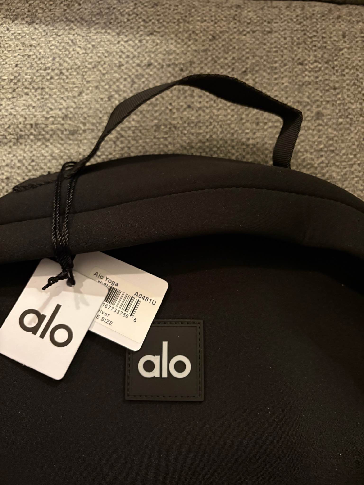 New Alo Yoga backpack is made of black neoprene material. It has a