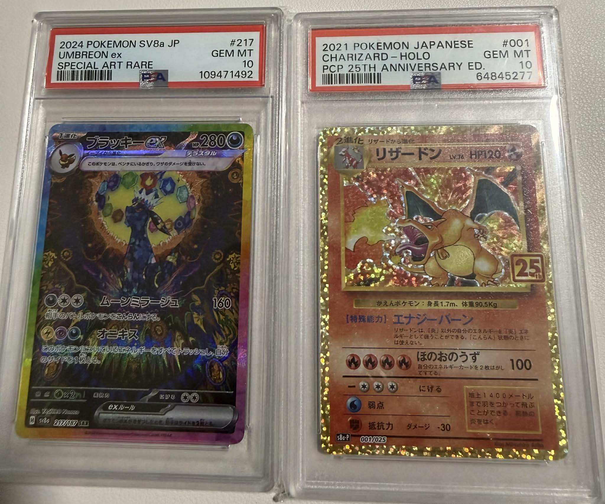 PSA 10 Umbreon and Charizard Pokémon cards for sale