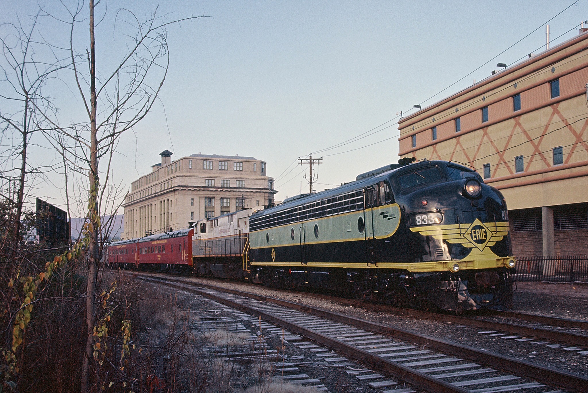 Erie Lackawanna E8 833 is shrouded in steam at a platform in