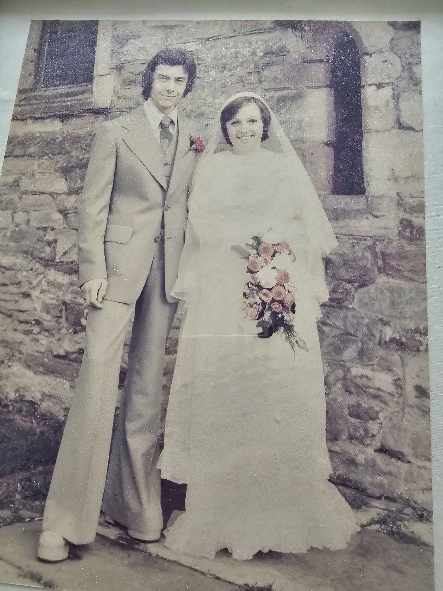 ivory wedding dress with grey suit Its my golden anniversary this August, could anybody brighten this photo up. My was and my flowers were orange and cream. My husbands was light blue/grey. Thankyou green cami dress