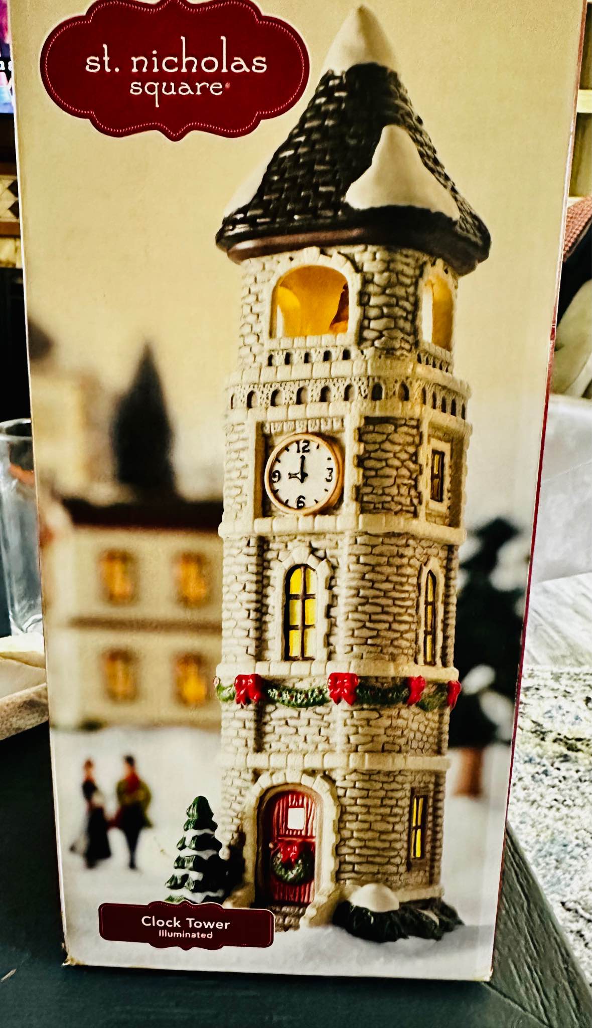 These images show the St. Nicholas Square Village Collection Clock