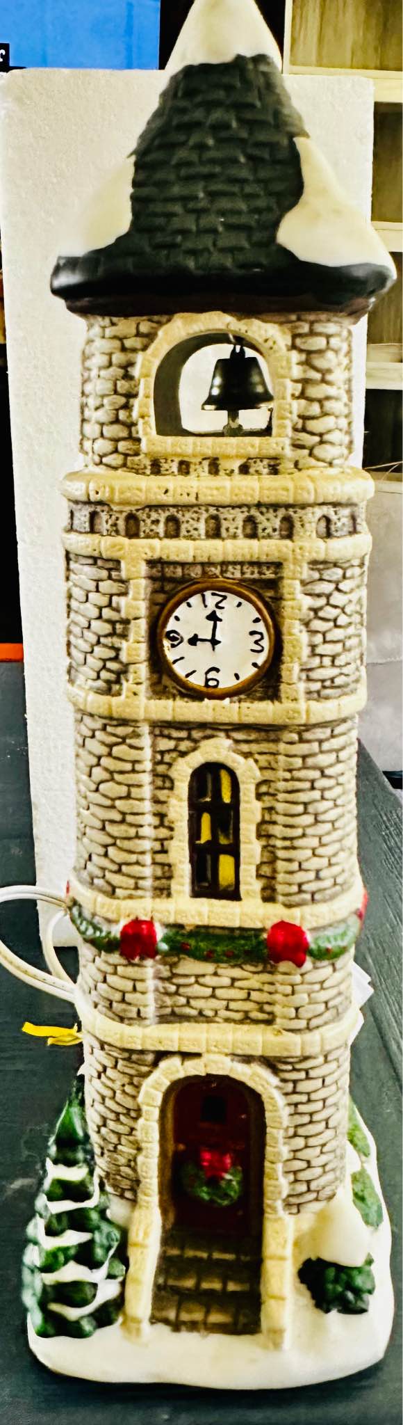 These images show the St. Nicholas Square Village Collection Clock