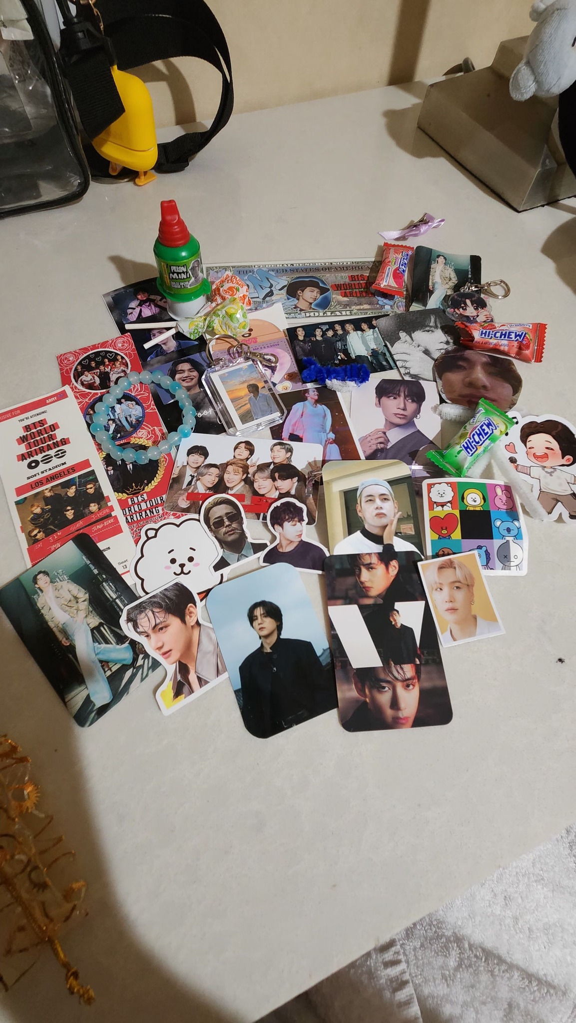 BTS-themed haul with photos, keychains, and stickers from LA D4 event