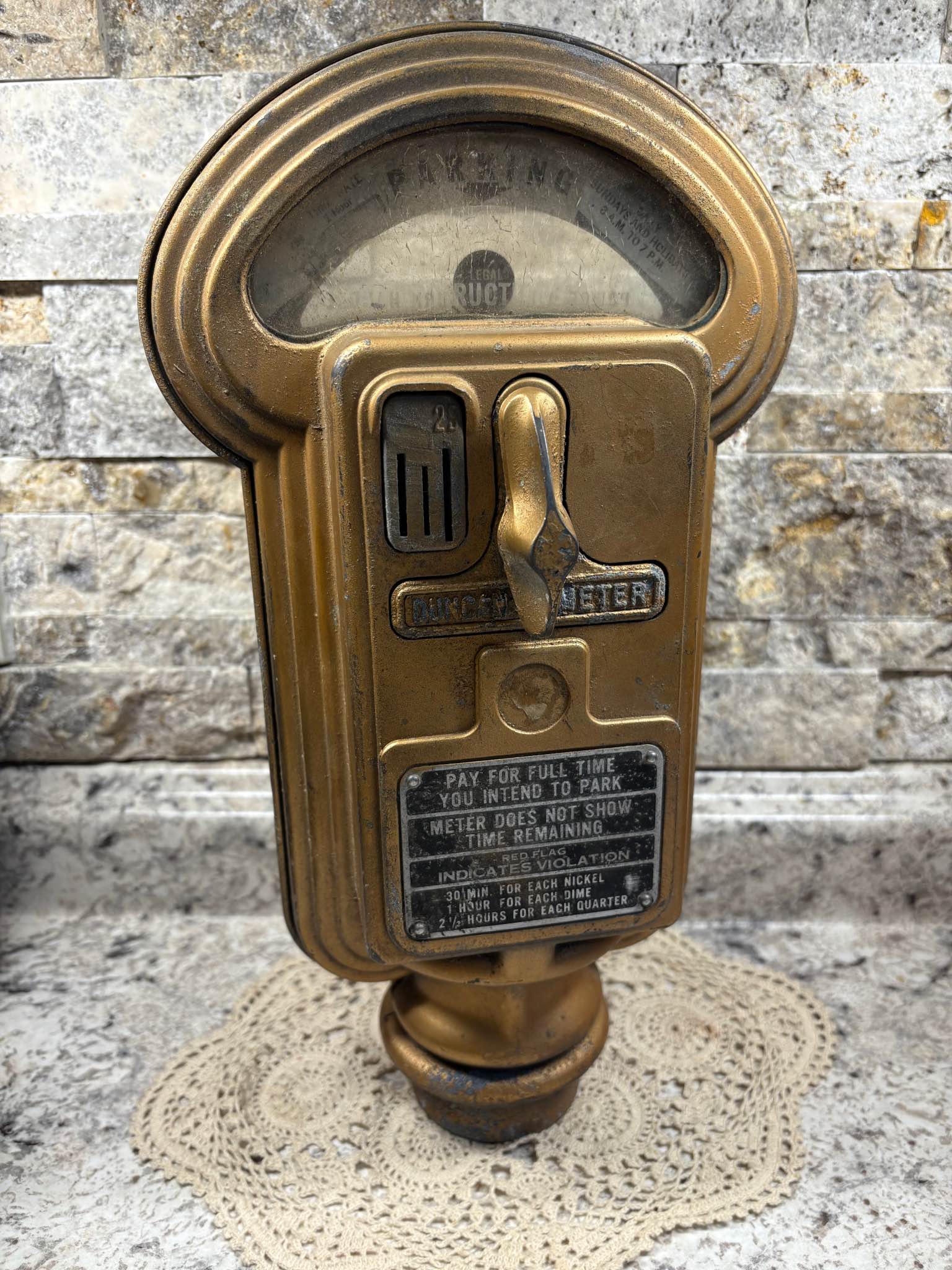 This Vintage gold-toned metal parking meter is a Duncan model. It