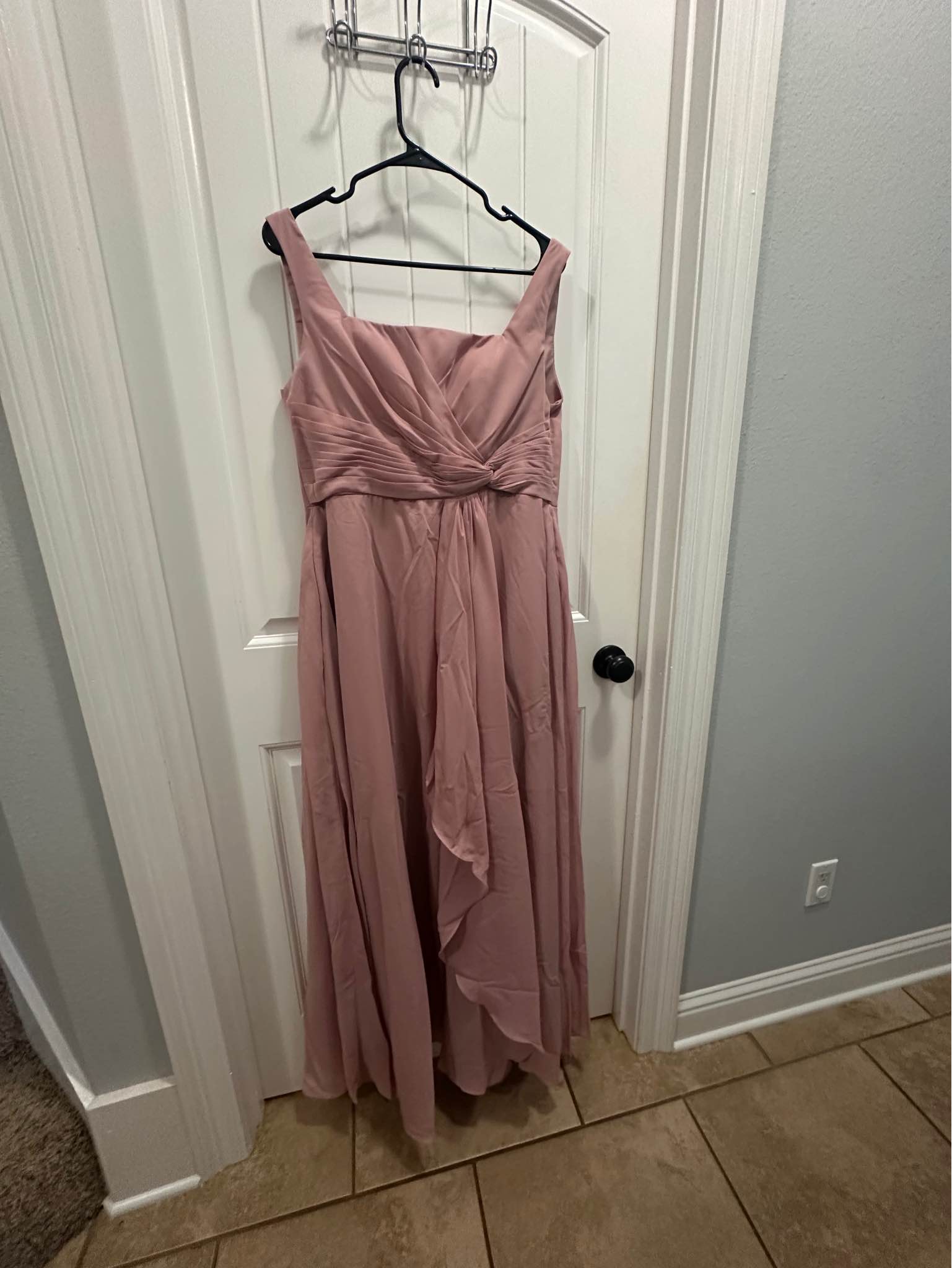 Size 10 Elegant chiffon bridesmaid dress in a dusty rose color. This floor-length gown has a pleated, wrap-style bodice with a square neckline and wide straps. The back is a lace-up corset