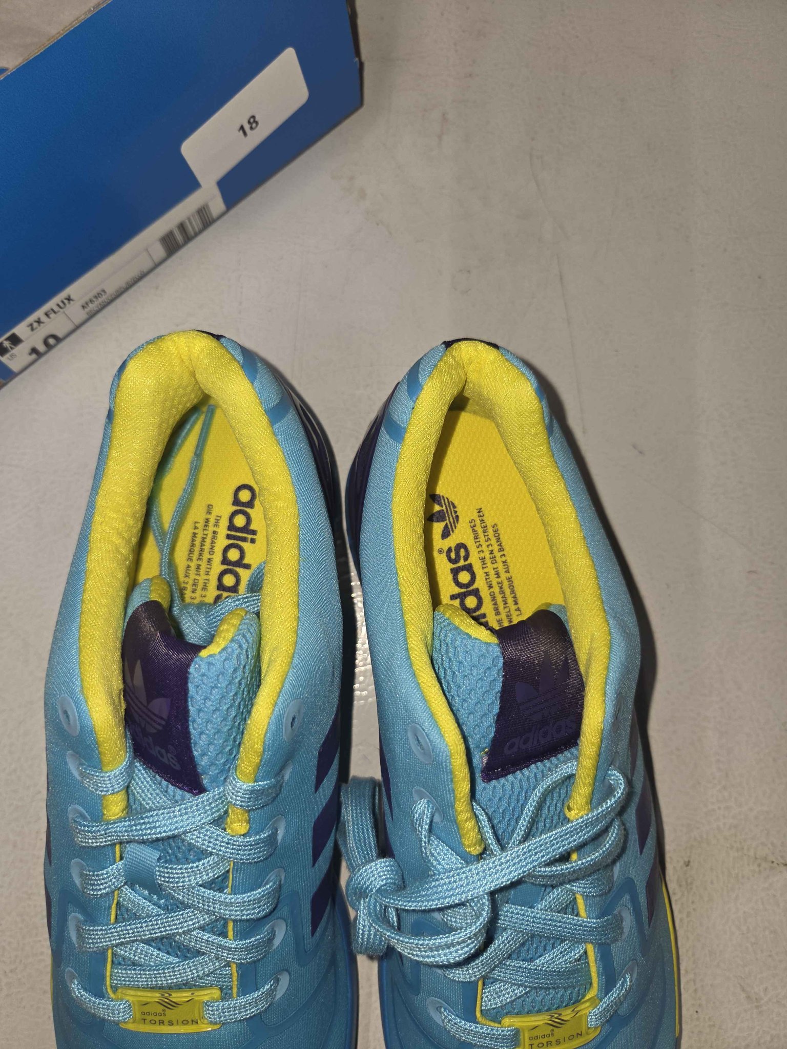 New adidas ZX Flux sneakers in bright cyan, purple, and yellow