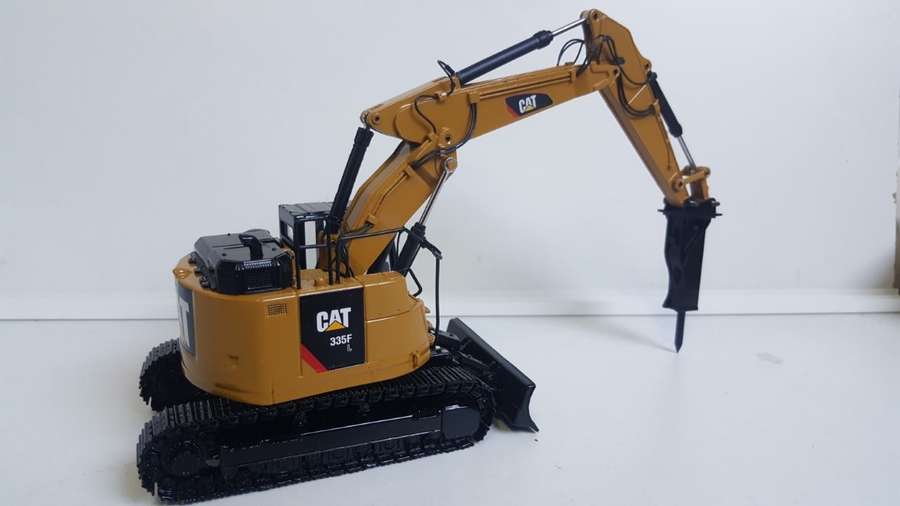 Cat 335F with triple-boom and hydraulic breaker. DCM 1/50