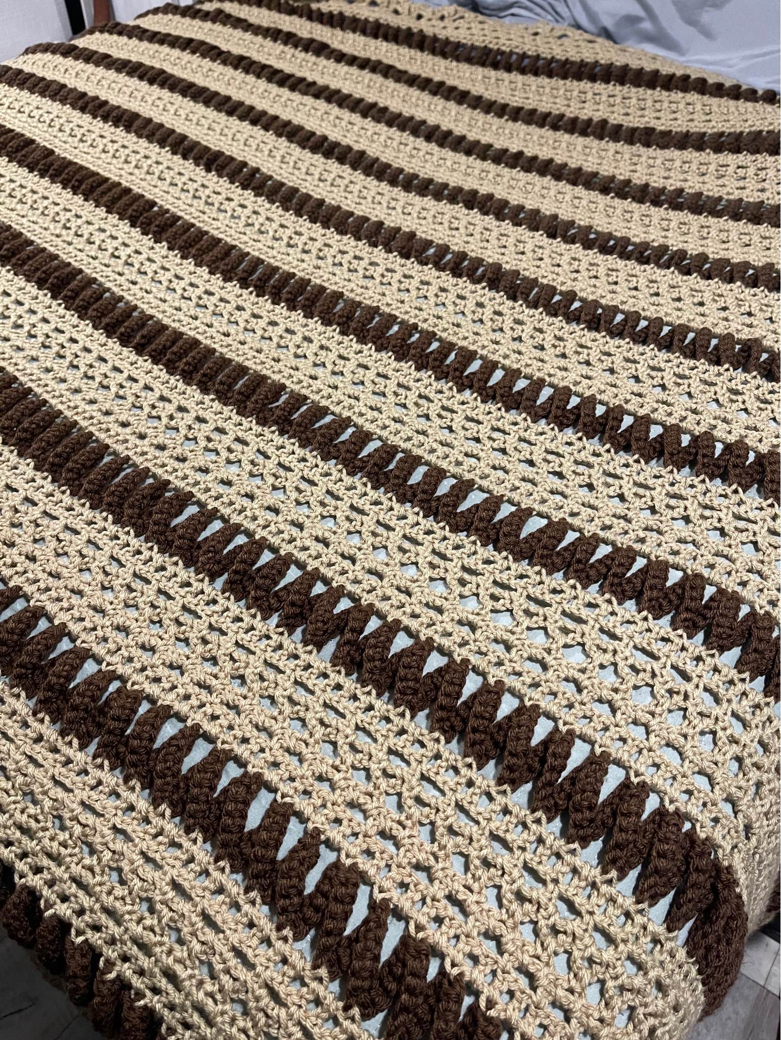 Handmade blanket/throw it has been displayed on a blanket ladder