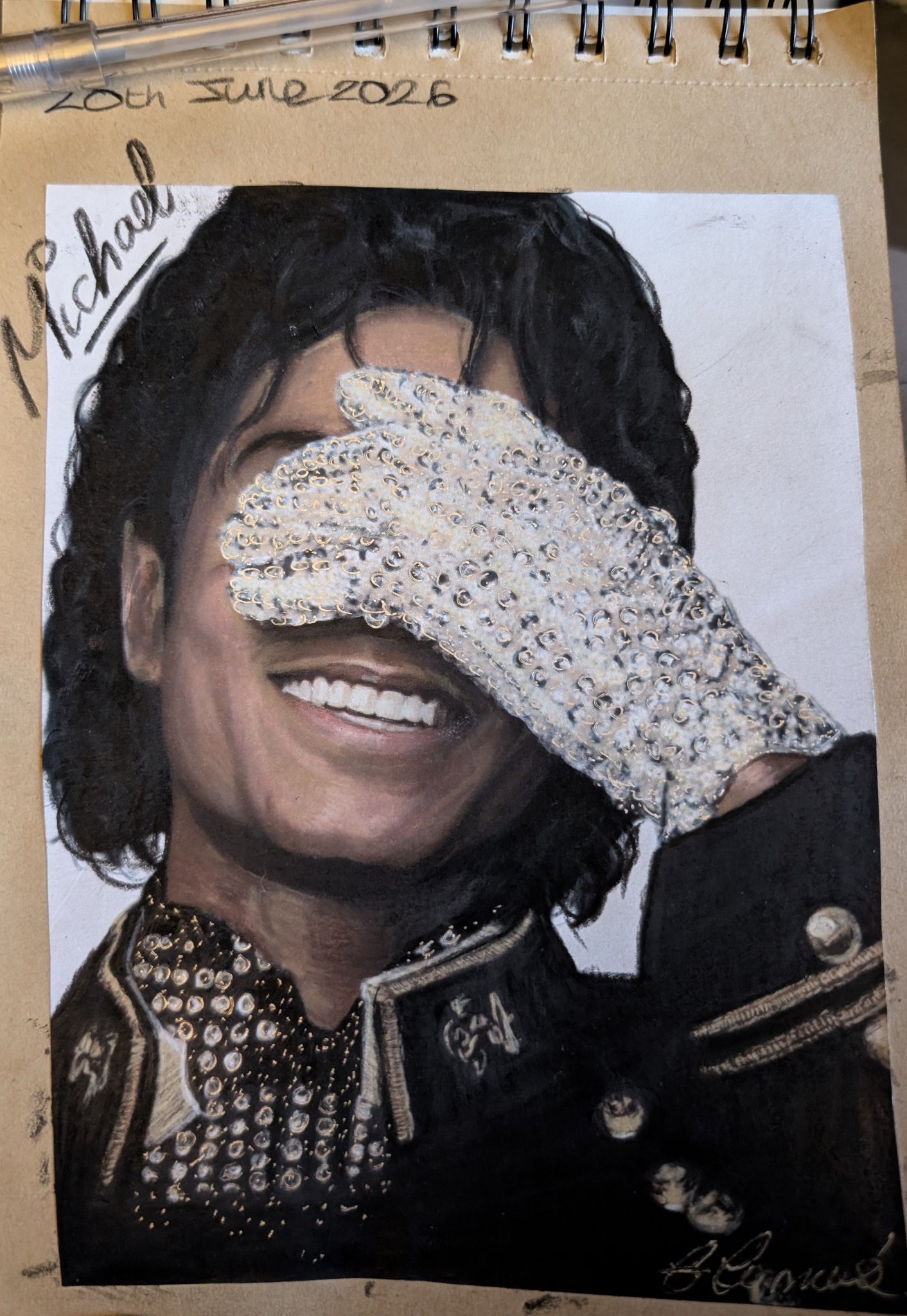 Michael Jackson drawing in a sparkly glove and studded jacket