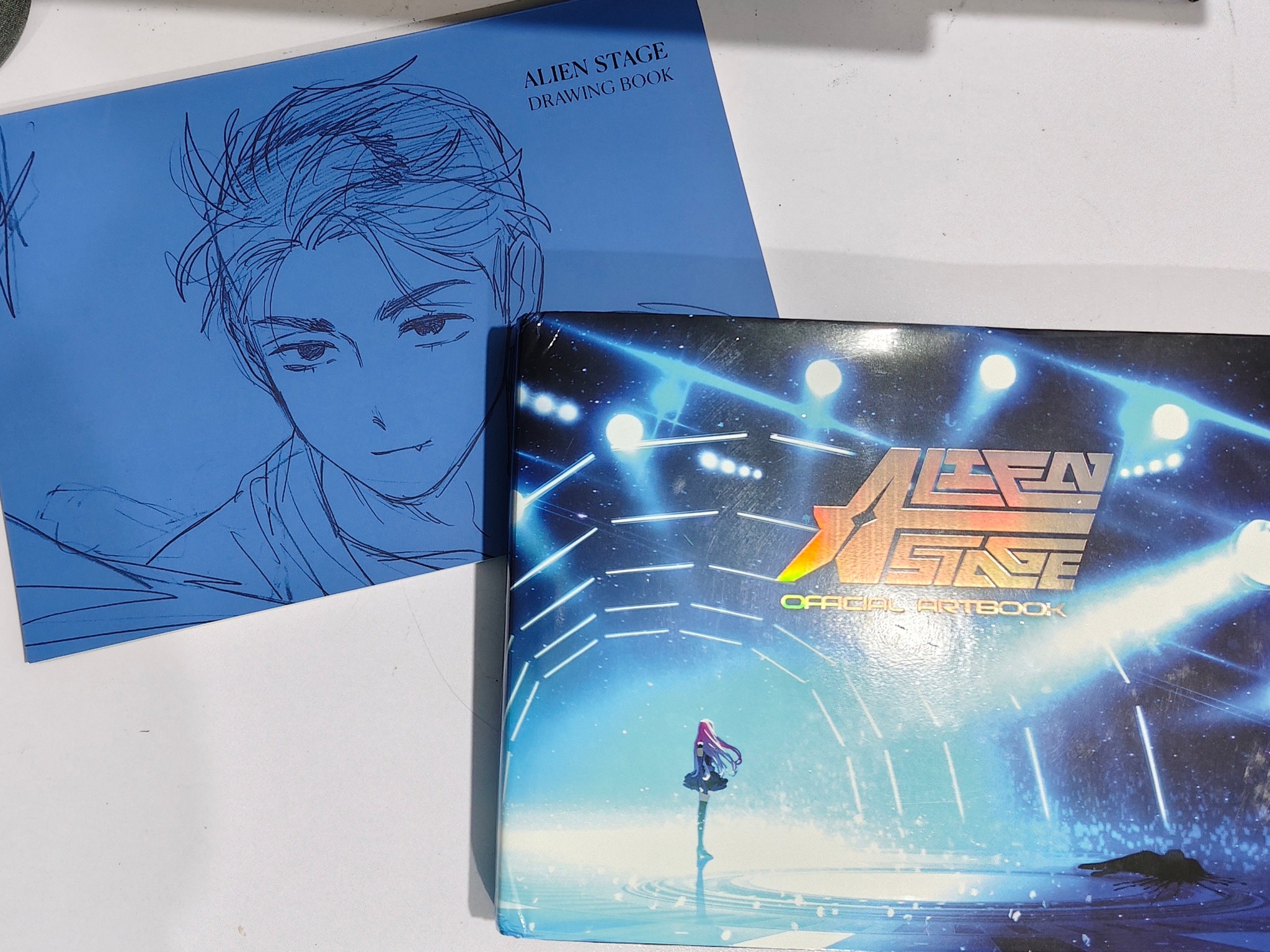 The Alien Stage Official Art Book is available online now! Both