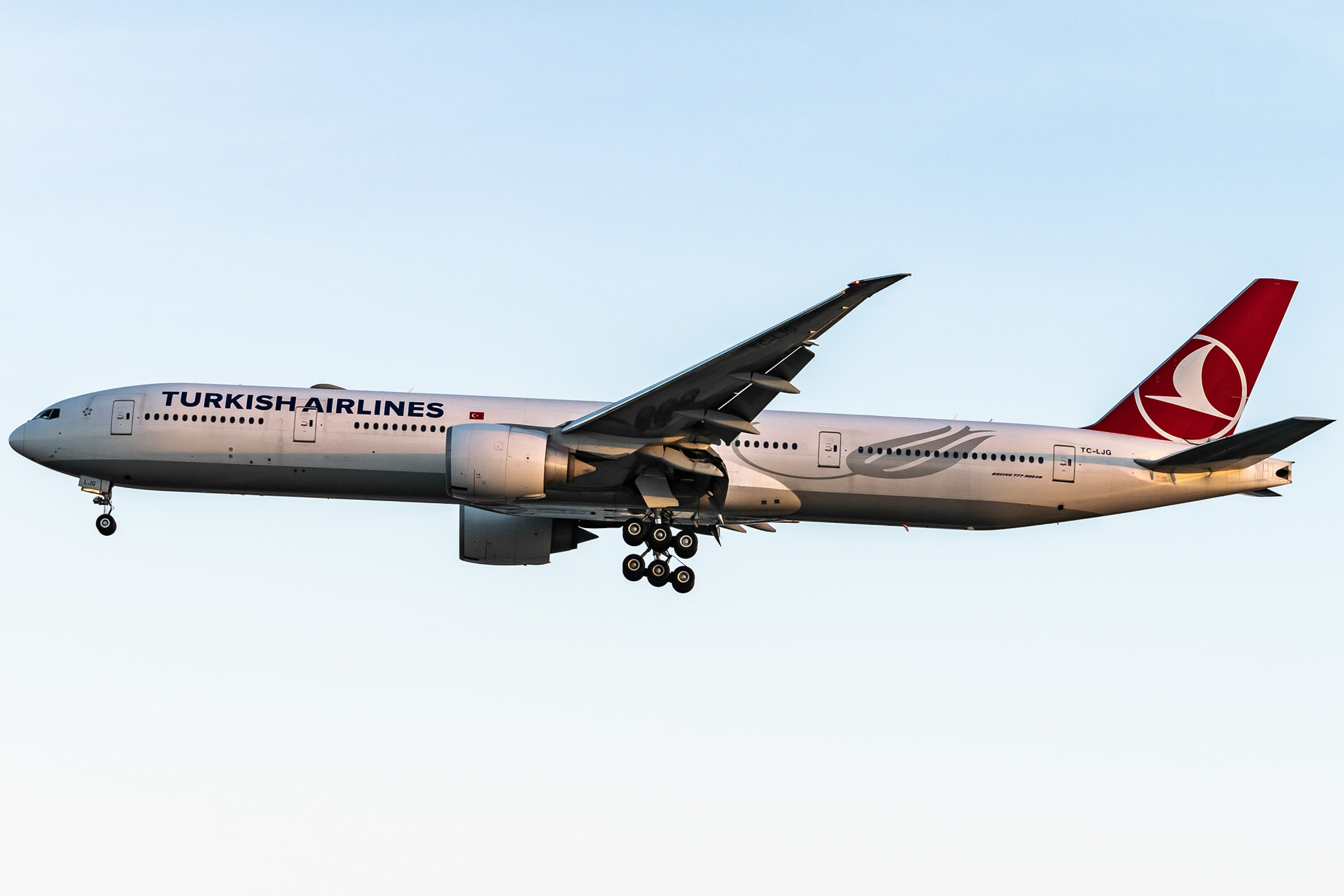A Turkish Airlines Boeing 777-300ER climbs out of Runway 25R at