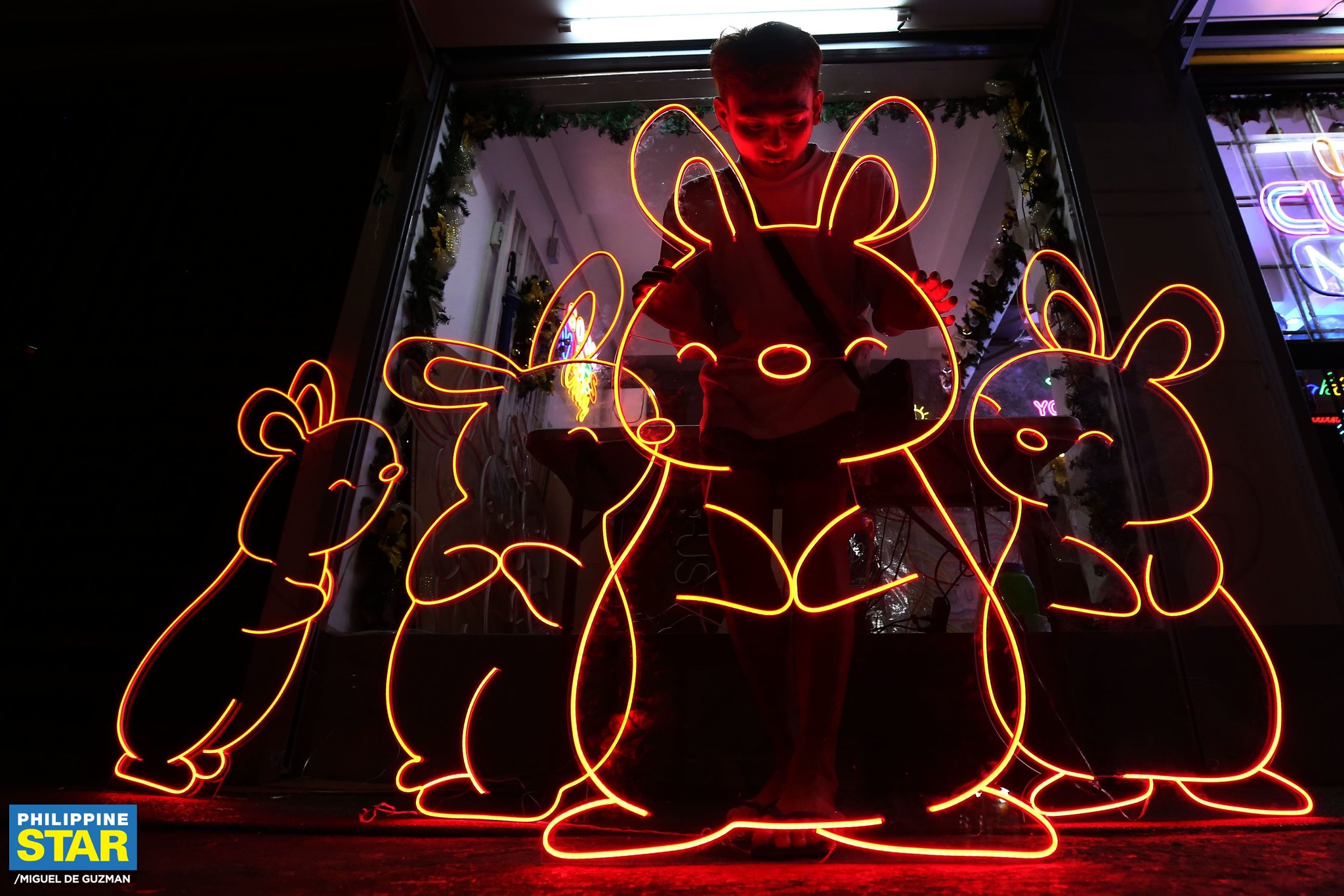 Philippine Star - Workers install LED light bunnies at a shop in Manila ...