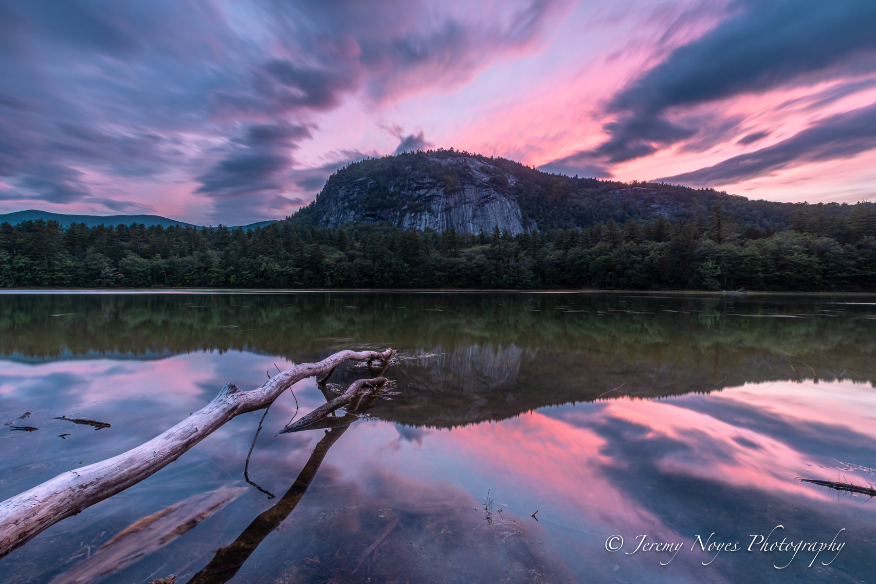 Stunning sunset over Cathedral Ledge and Echo Lake in Conway, New