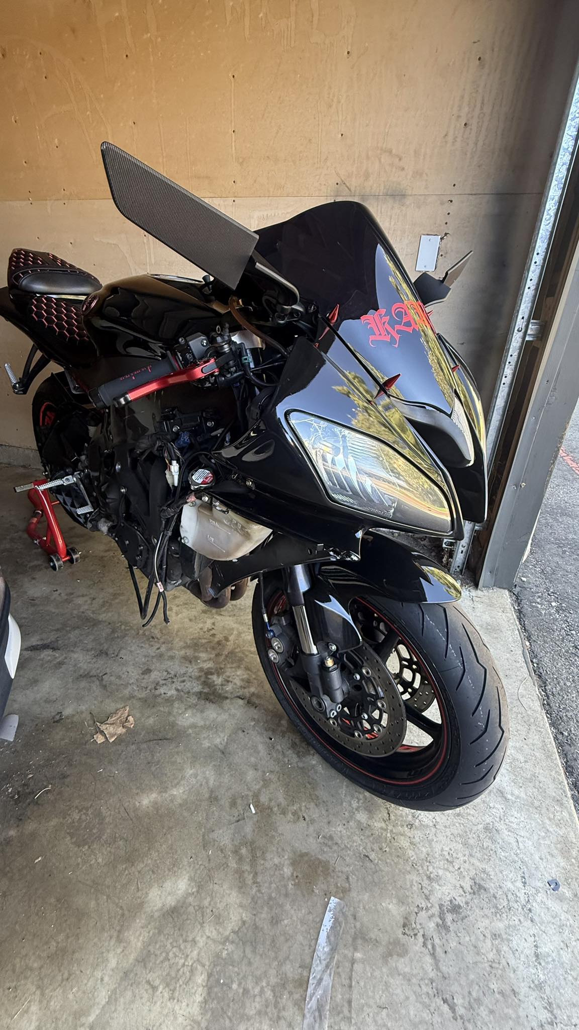 Why does my Yamaha YZF R6 overheat while riding?