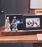 The statues on Namjoon's desk next to BTS photo & concert photo