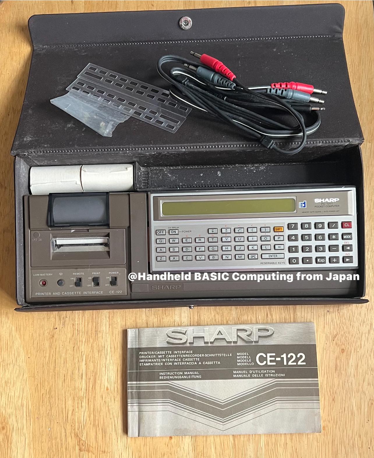 Vintage Sharp PC-1270 pocket computer is paired with a CE-123P