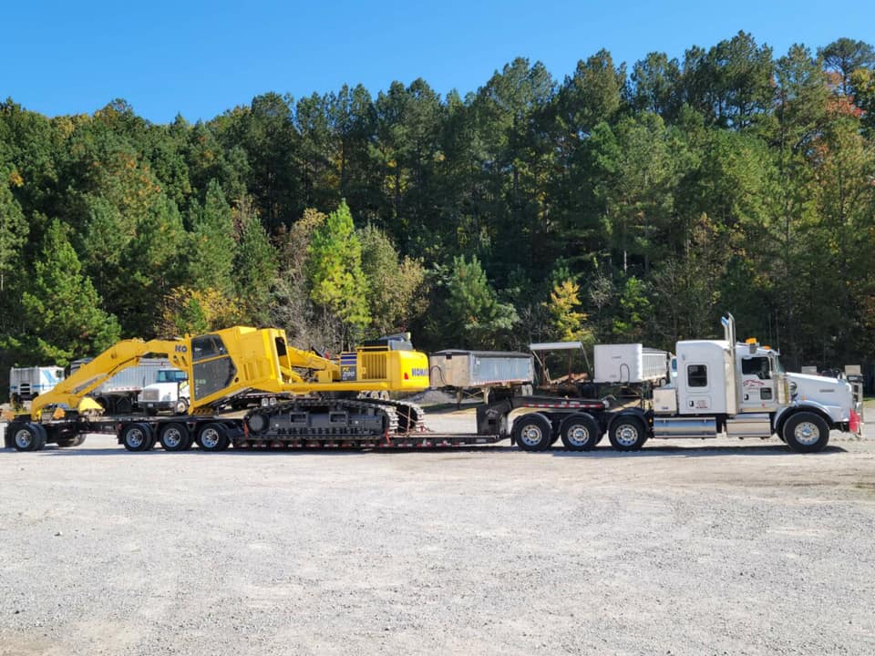 Isaac loaded a KOMATSU PC 290 log... - S&T Trucking, Inc.