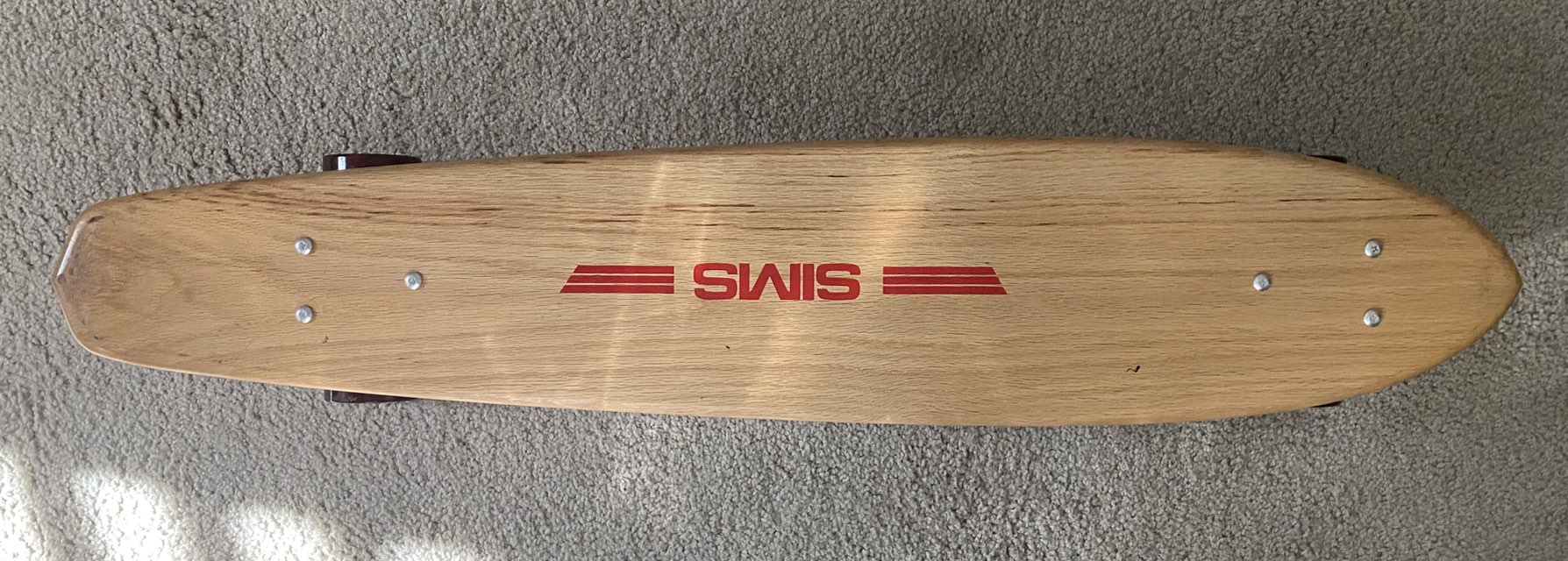 Vintage 1970s skateboard with Sims deck and Powell wheels