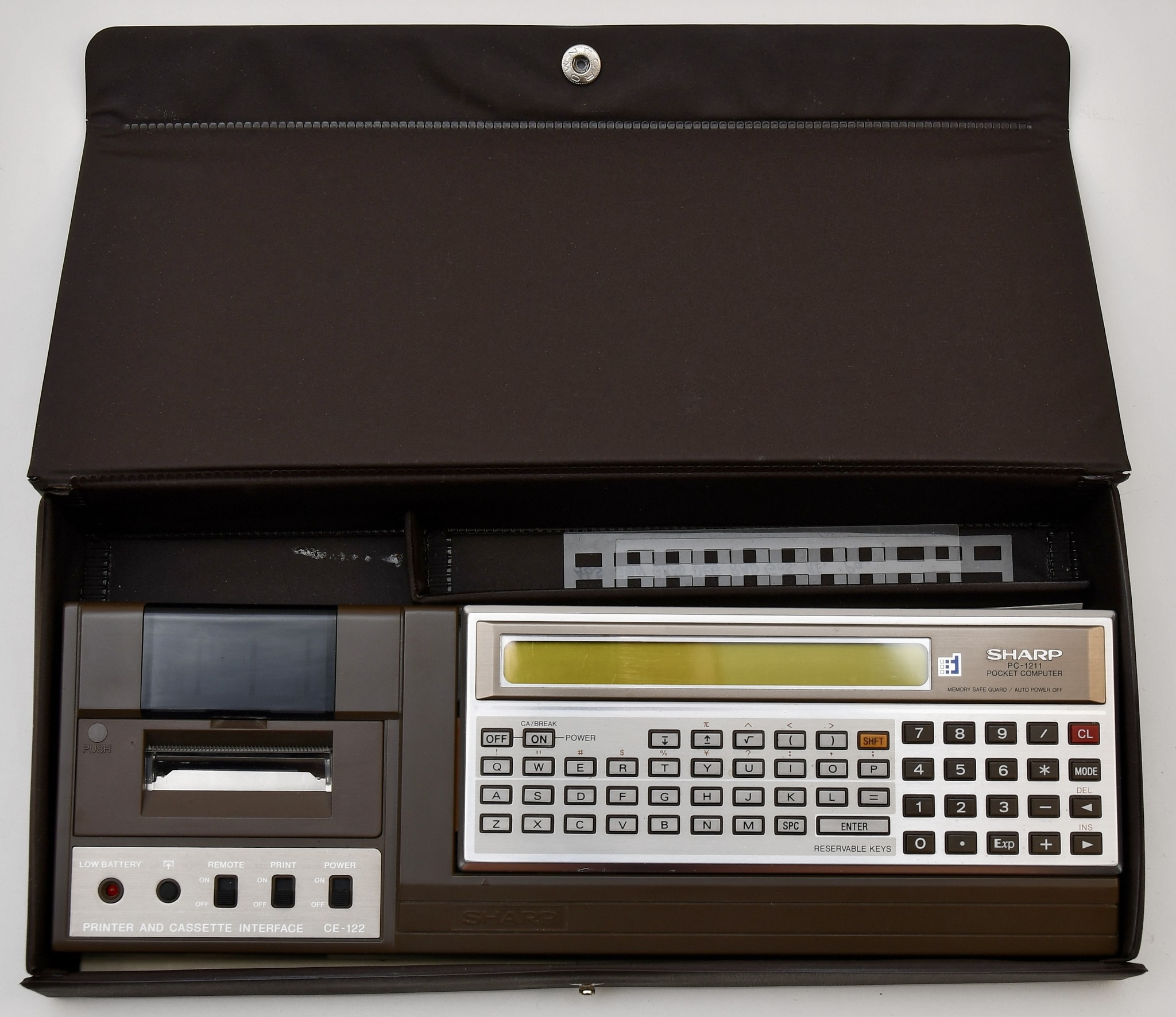 A Sharp PC-1260 Pocket Computer , complete with a Sharp CE-125