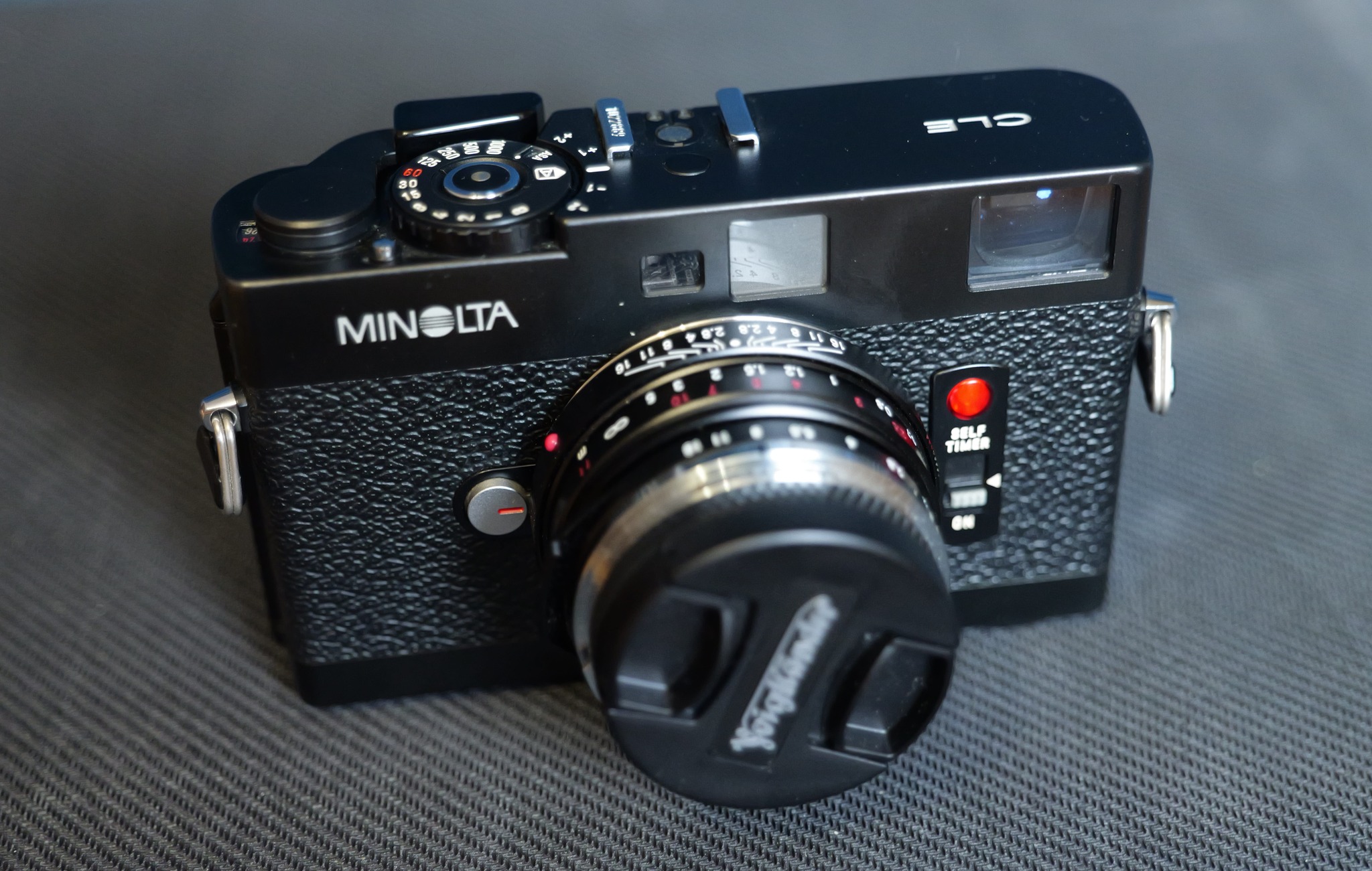 I recently bought a Minolta CLE. It's really small and light.
