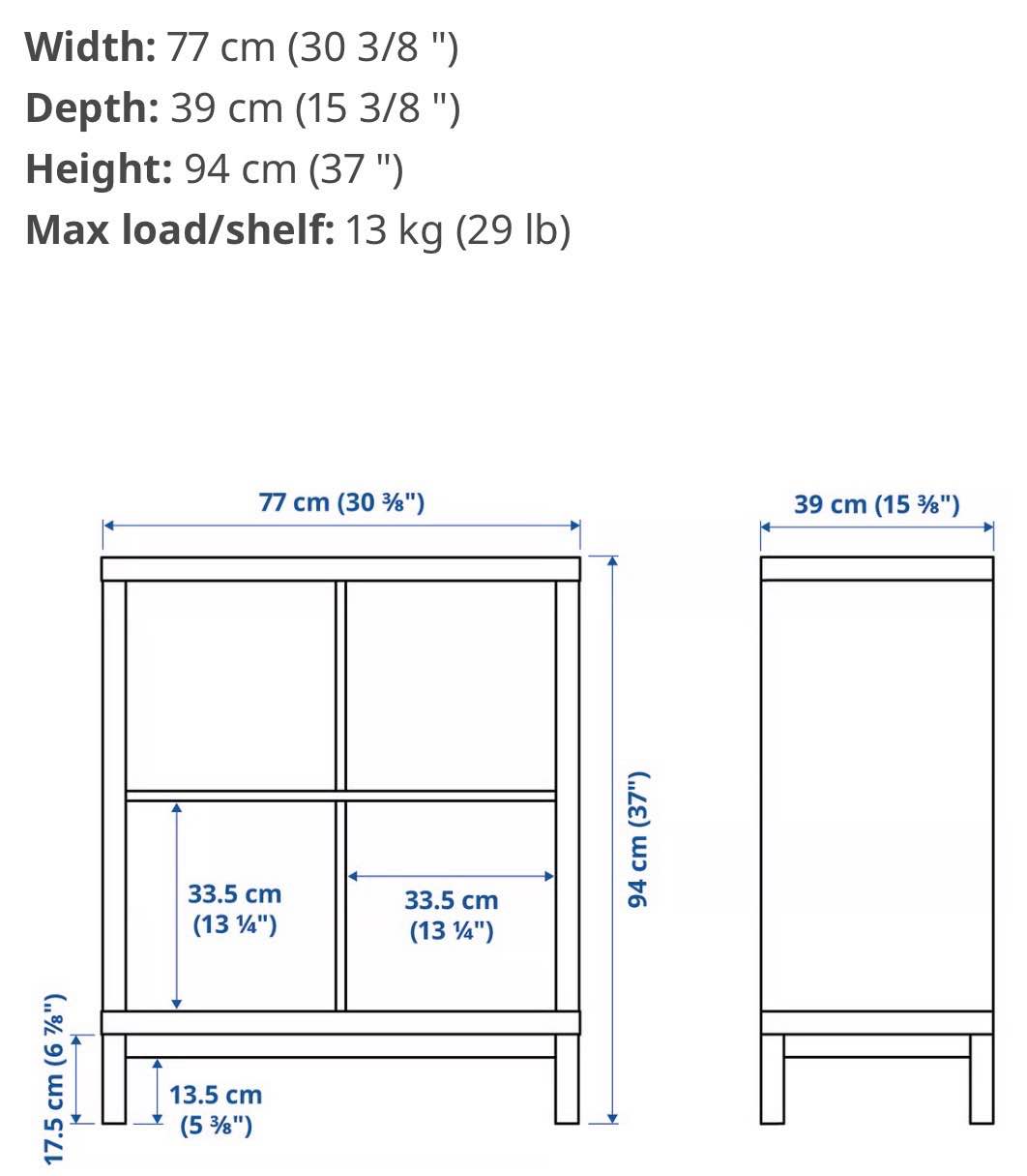 Modern 8-cube IKEA Kallax Cabinet. This shelving unit has a 2x4 grid configuration and stands on four black tapered metal legs. The piece has a smooth matte finish and open-back design. Estimated (