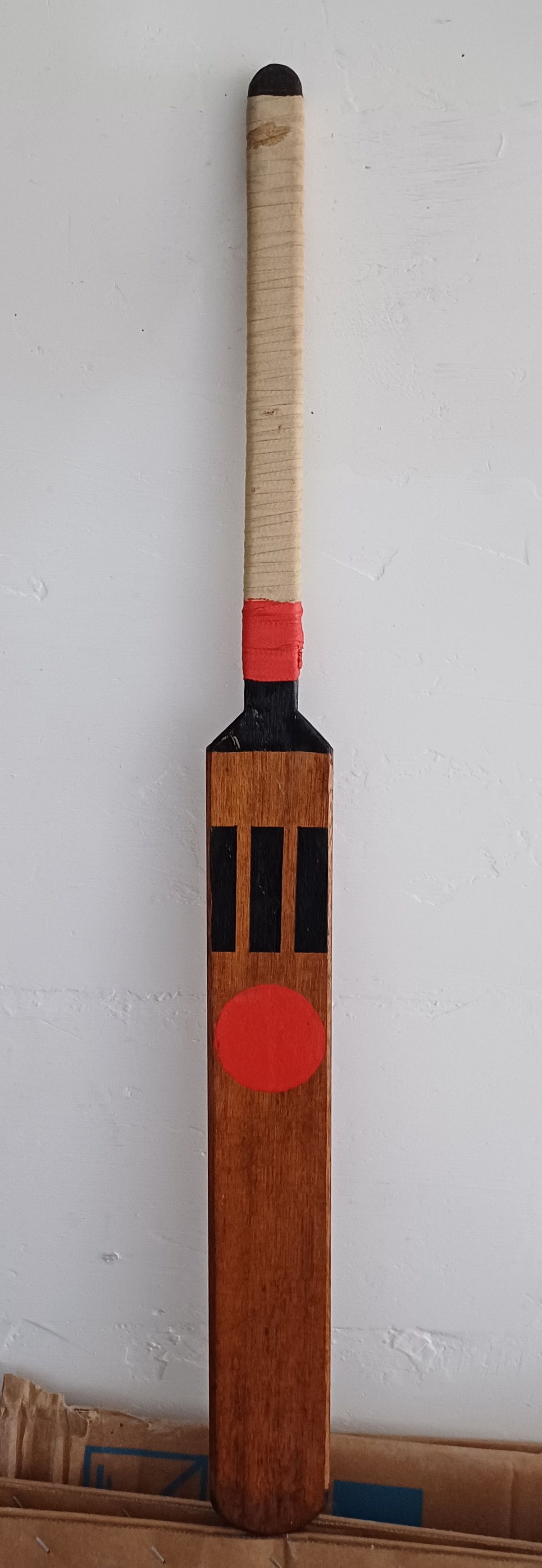 Old cricket bats resting in a corner, holding memories of 