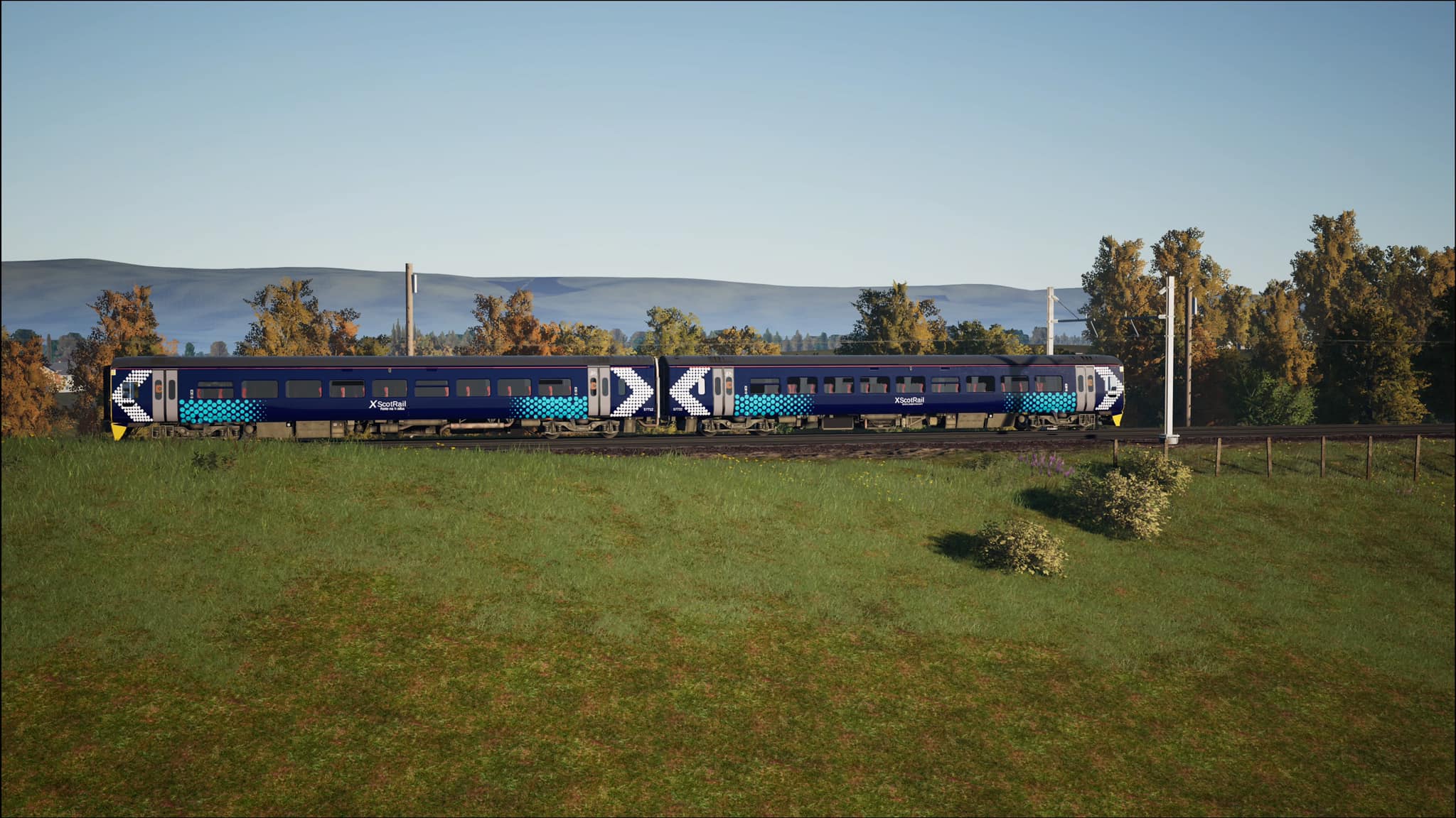 Double class 158 train passes through trees near Edinburgh Waverley