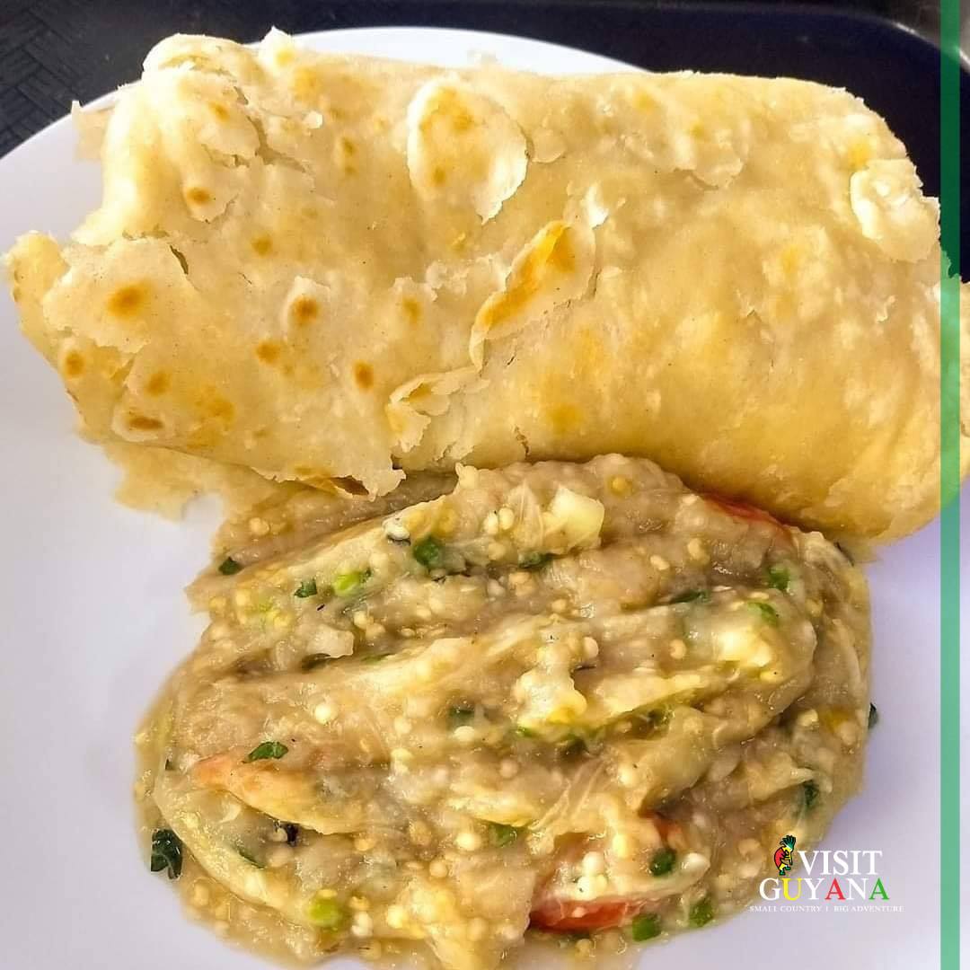 Visit Guyana - Baigan choka and roti for breakfast,...