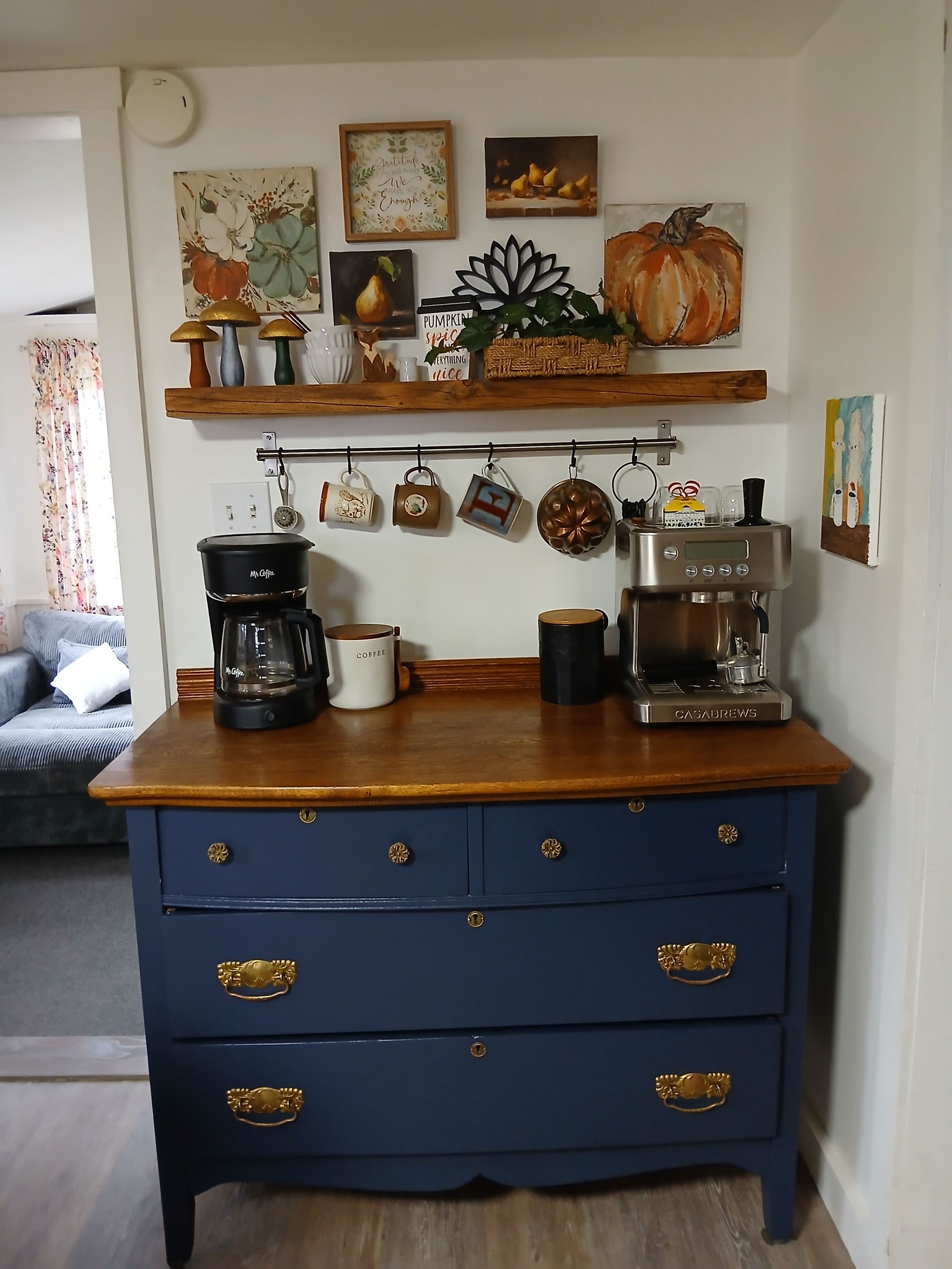 Upcycled oak dresser with navy blue paint and thrifted decor