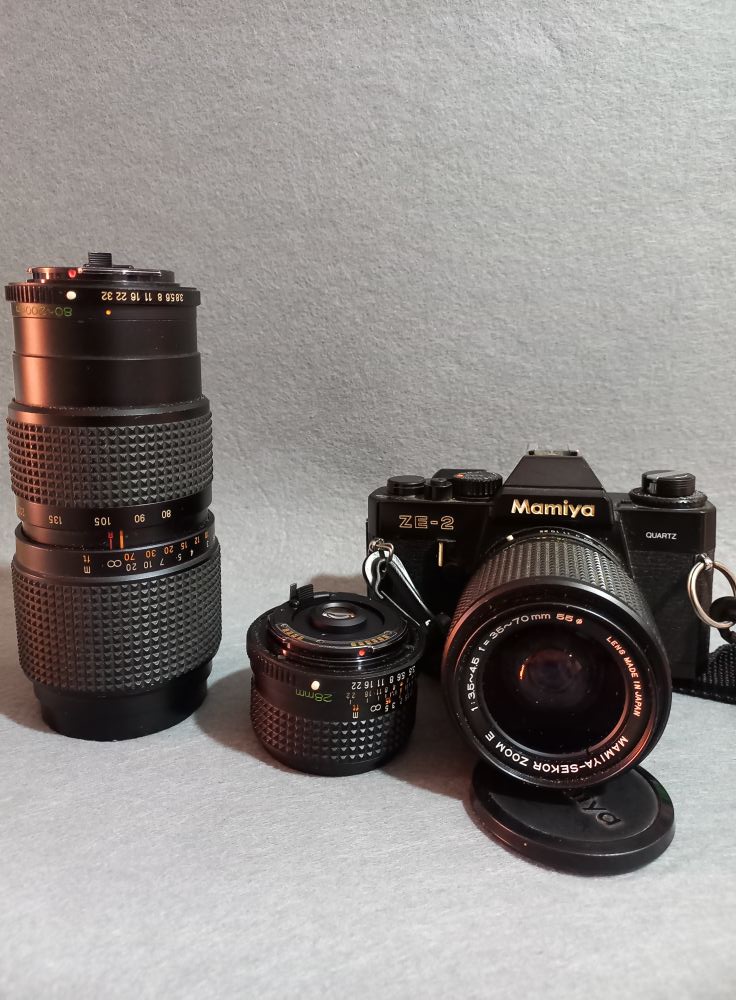 Two Mamiya 90mm f/3.8 Sekor lenses. One's well-loved, the other's