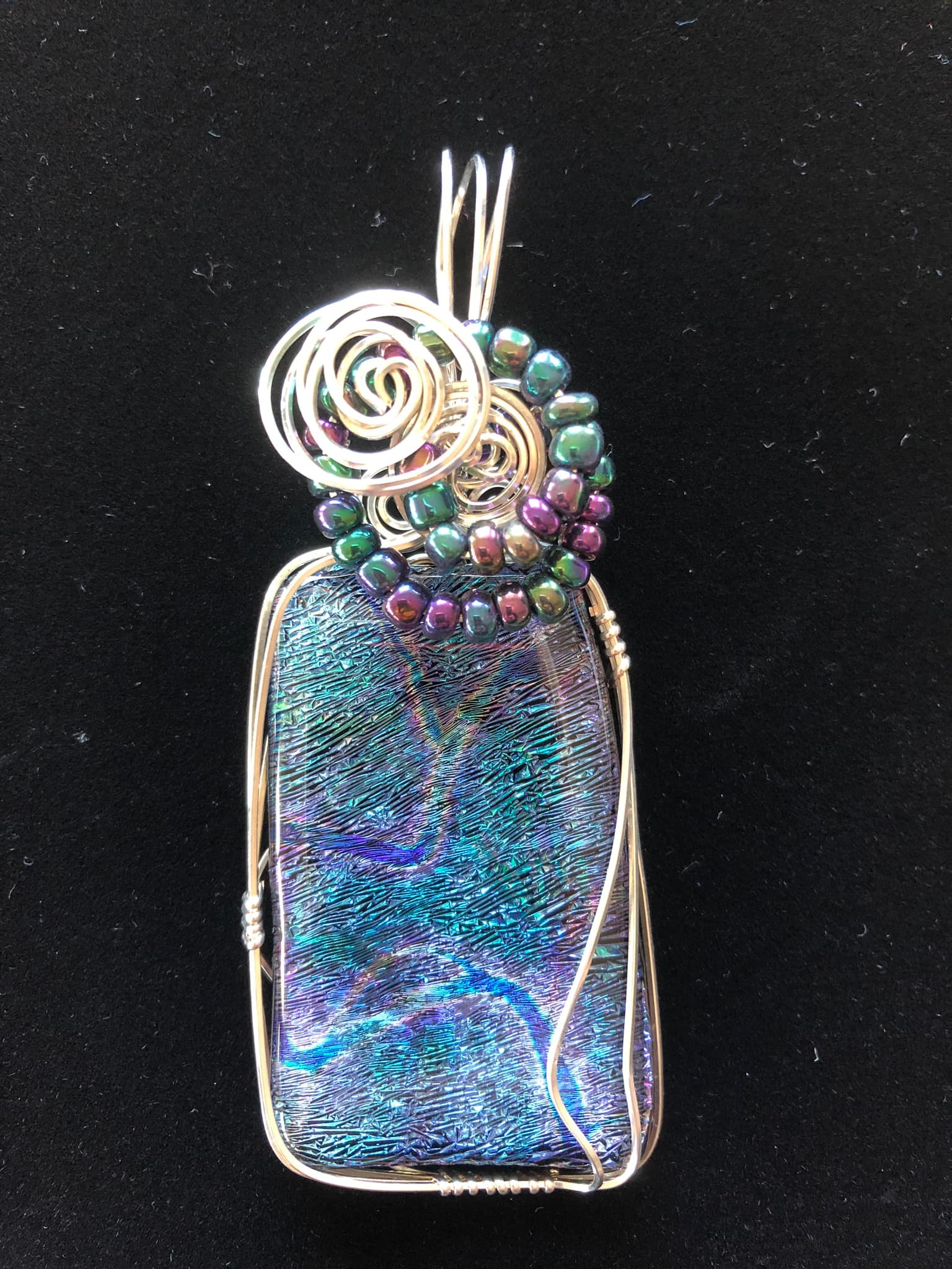 What glass has pink, blue, green, and purple colors?