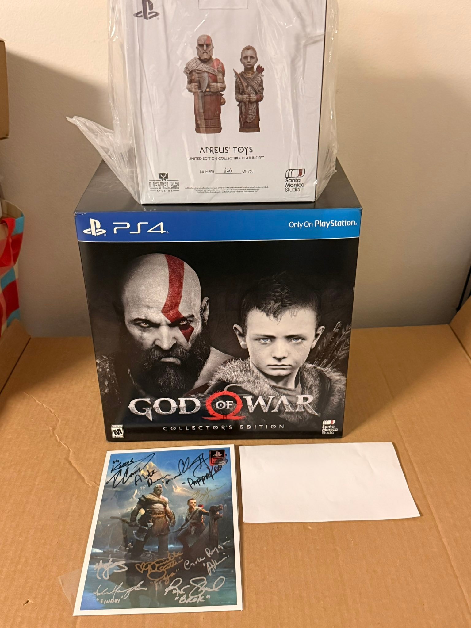 God of War collector's edition with signed print and Atreus toys