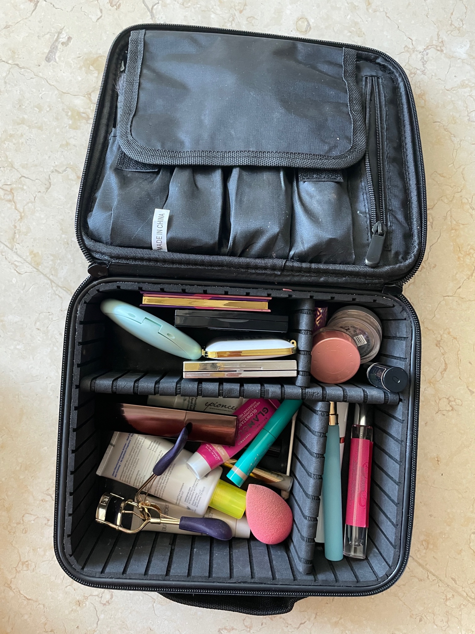 After testing countless options, I've used this under-$25 Amazon makeup bag for over four years—it keeps products organized, cleans easily, and still looks brand new after every trip. Click the link below