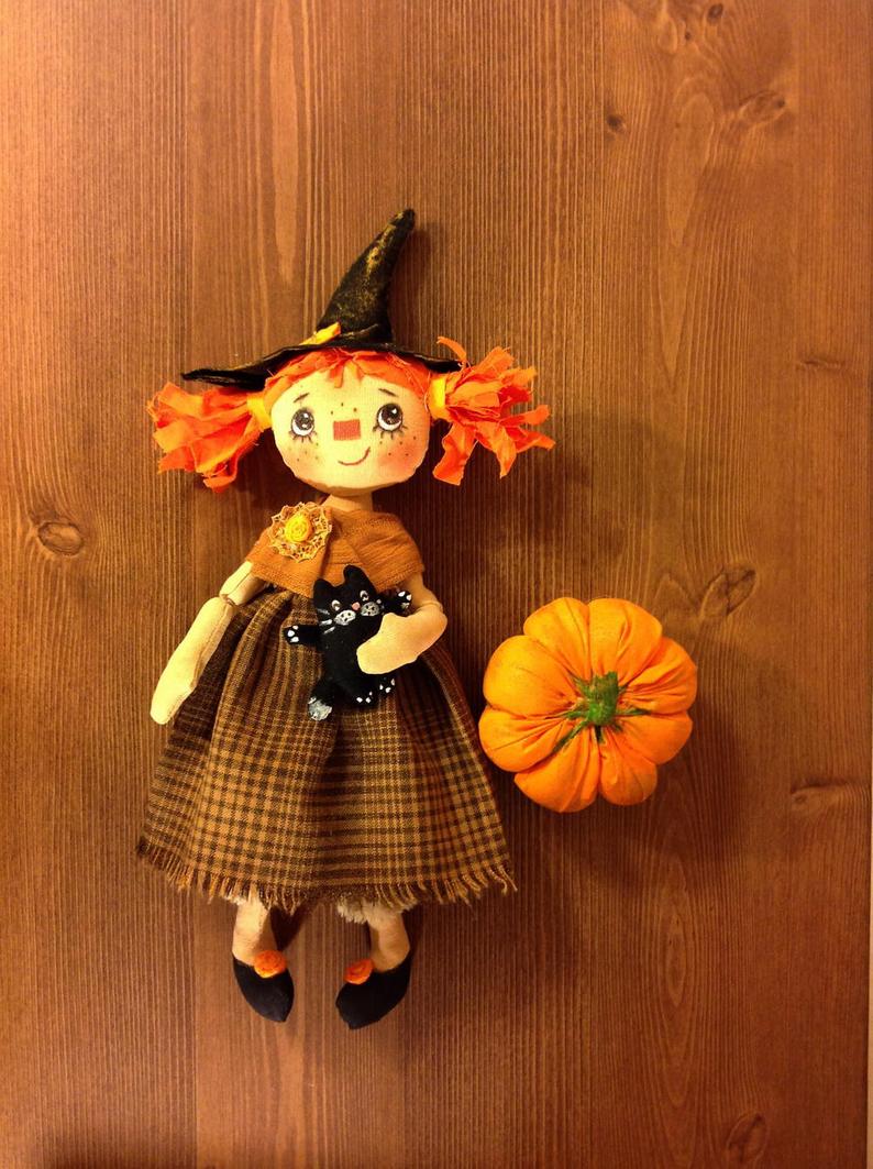 Handcrafted witch doll is made of felt and fabric. The doll has a