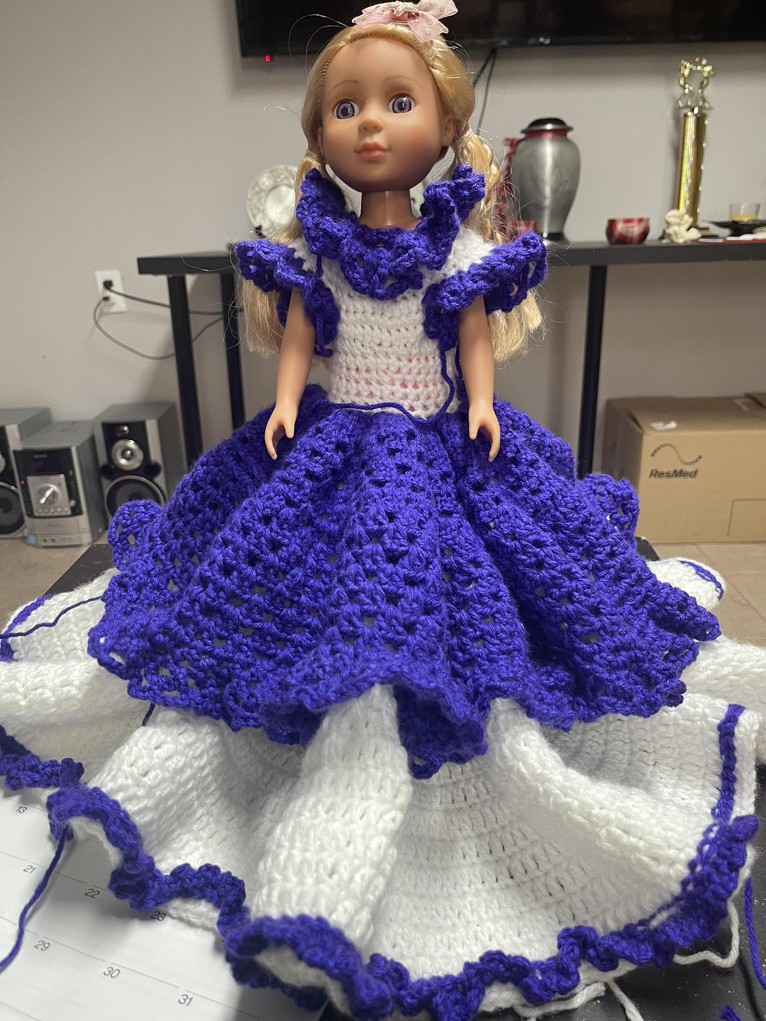 Crocheting a doll's dress with ruffles and flowers