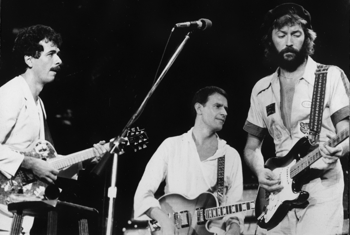 John appearing with Carlos Santana and Eric Clapton at the Nassau 