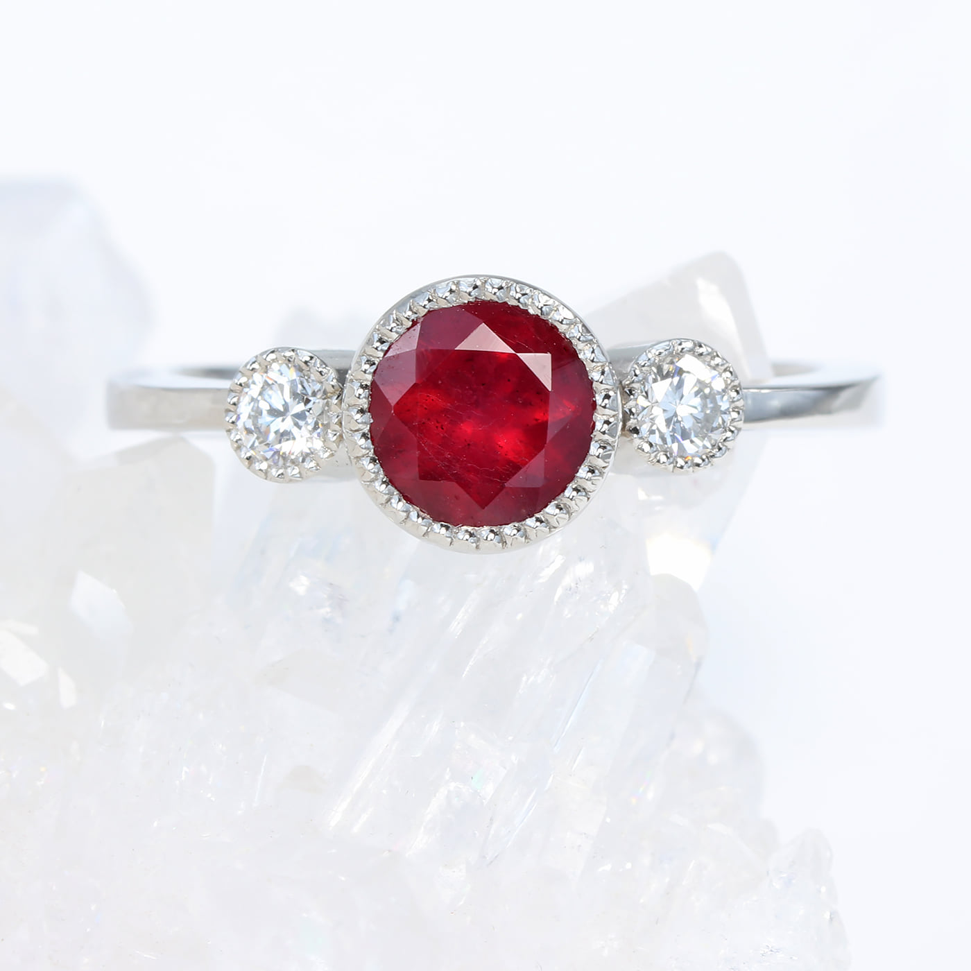 Set with a beautiful deep red ruby, this platinum trilogy ring is a ...