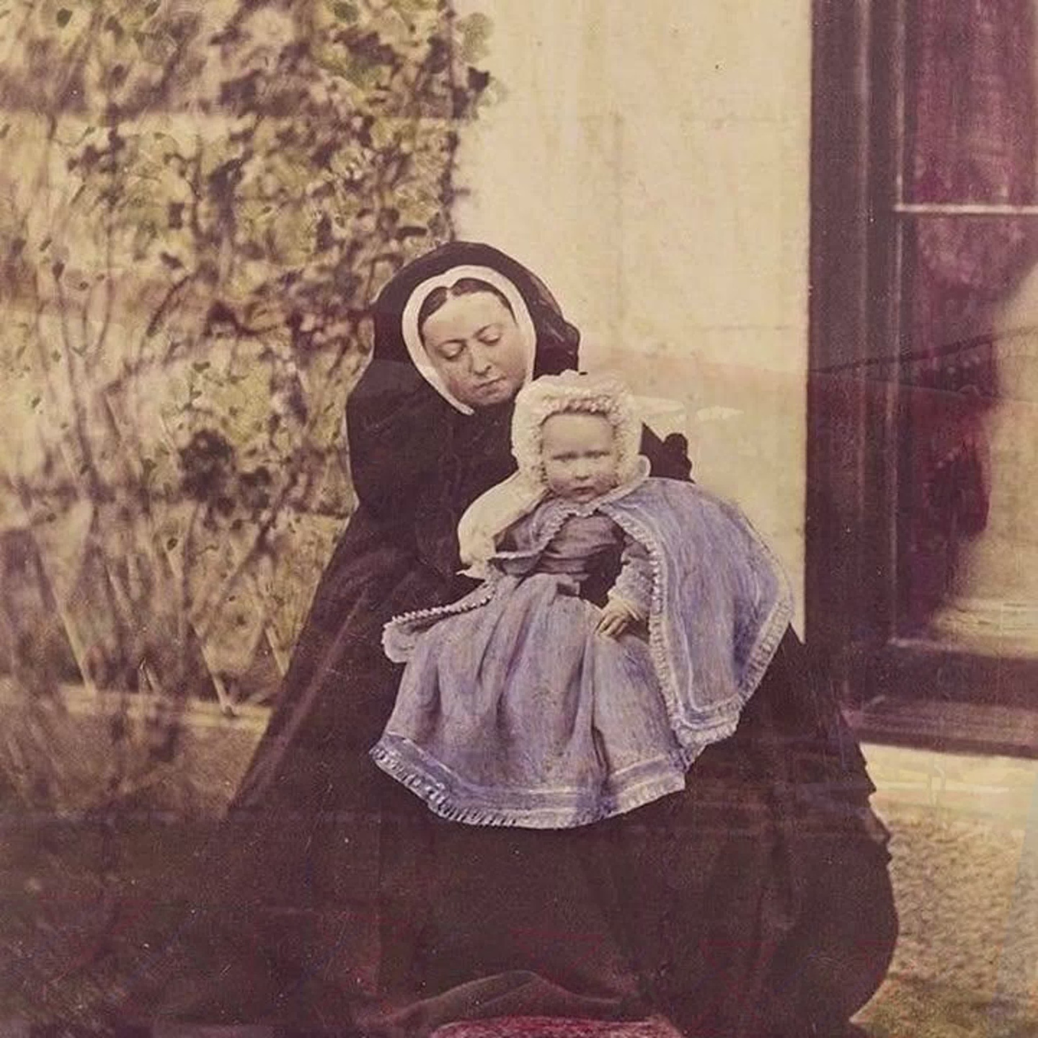 Hand-coloured photograph of Queen Victoria with her granddaughter