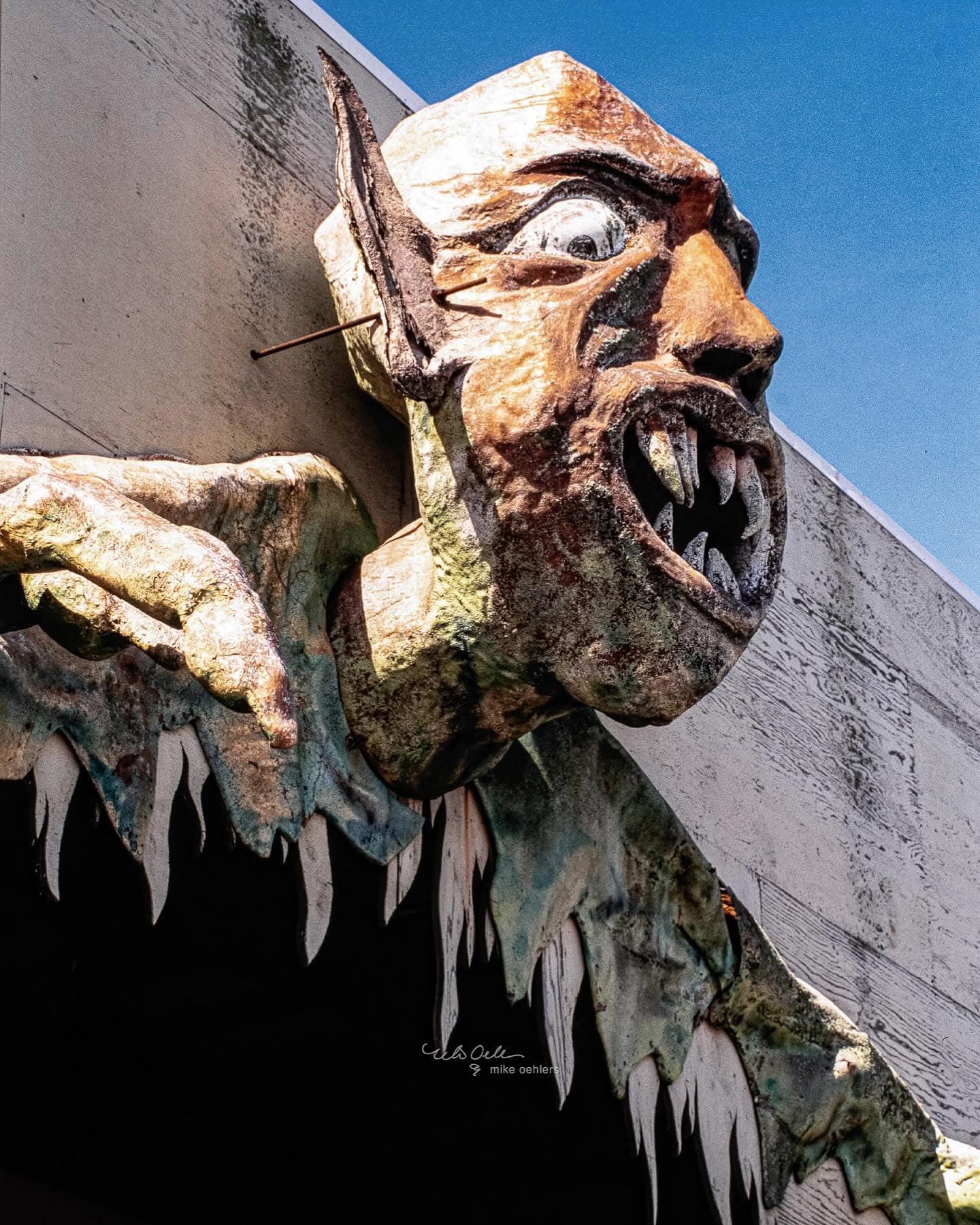 Vintage photo of a grotesque face sculpture at Sportland Pier in