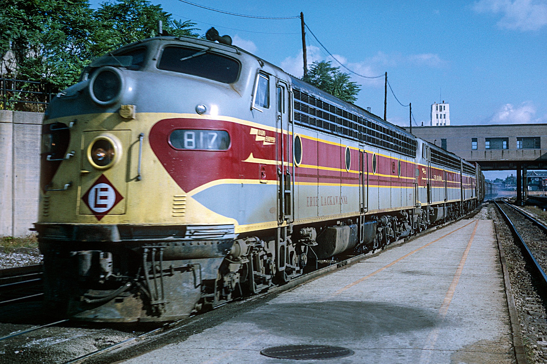 Erie Lackawanna E8 833 is shrouded in steam at a platform in