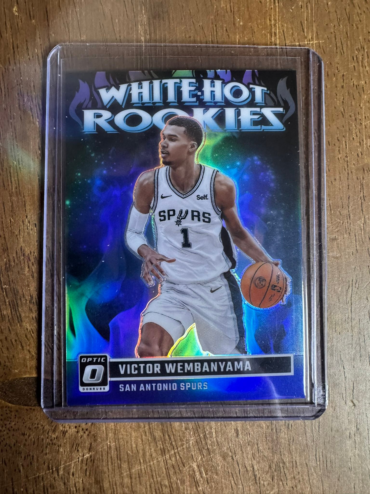 Pulling a Wemby rookie card from a panini box
