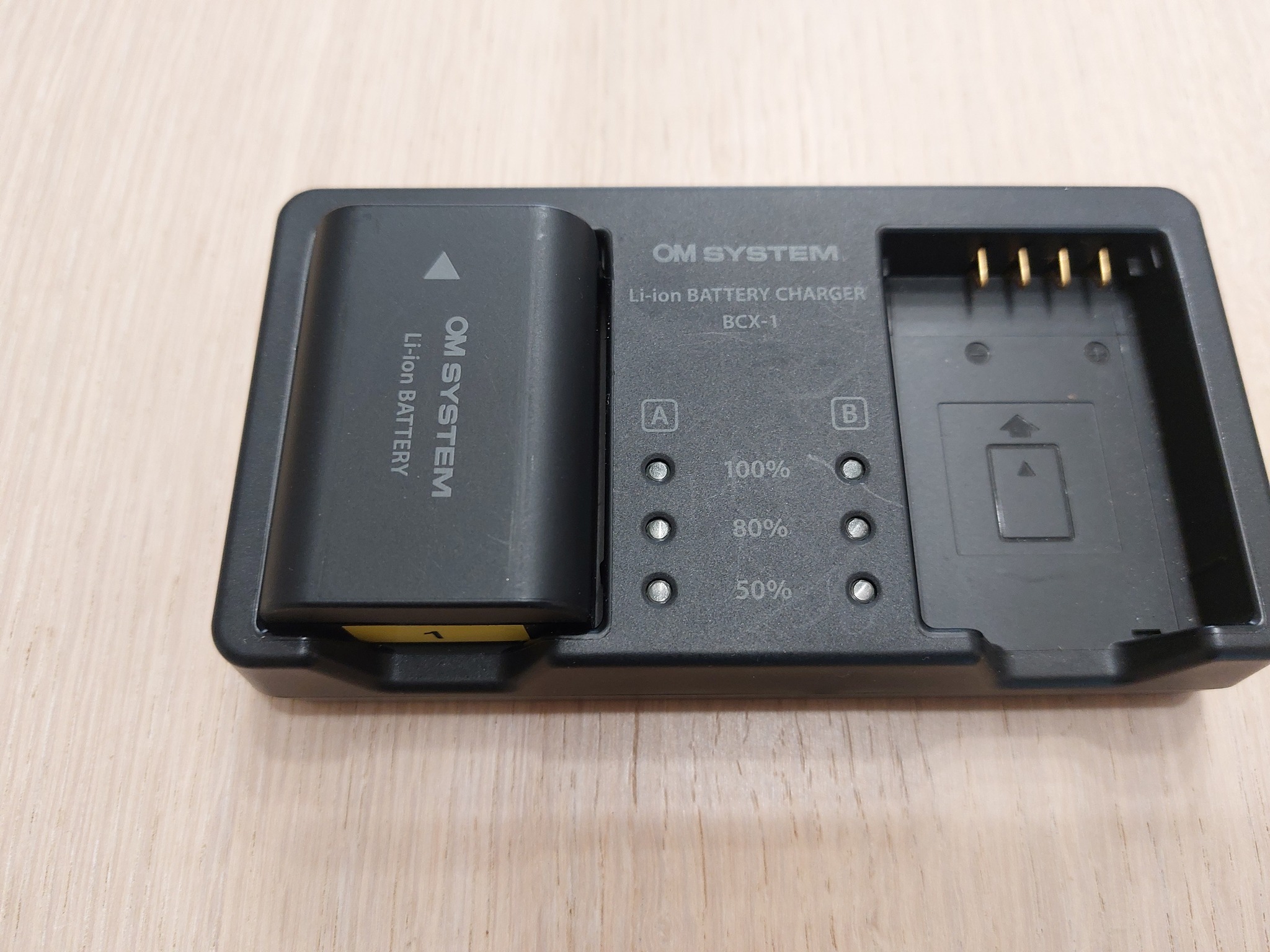 Why is the OM System BCX-1 charger so slow?