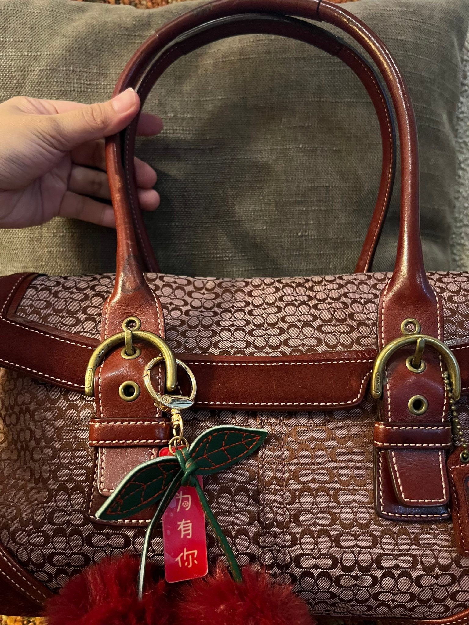 This handbag is a Francesco Biasia Secret Love Bag, a designer 