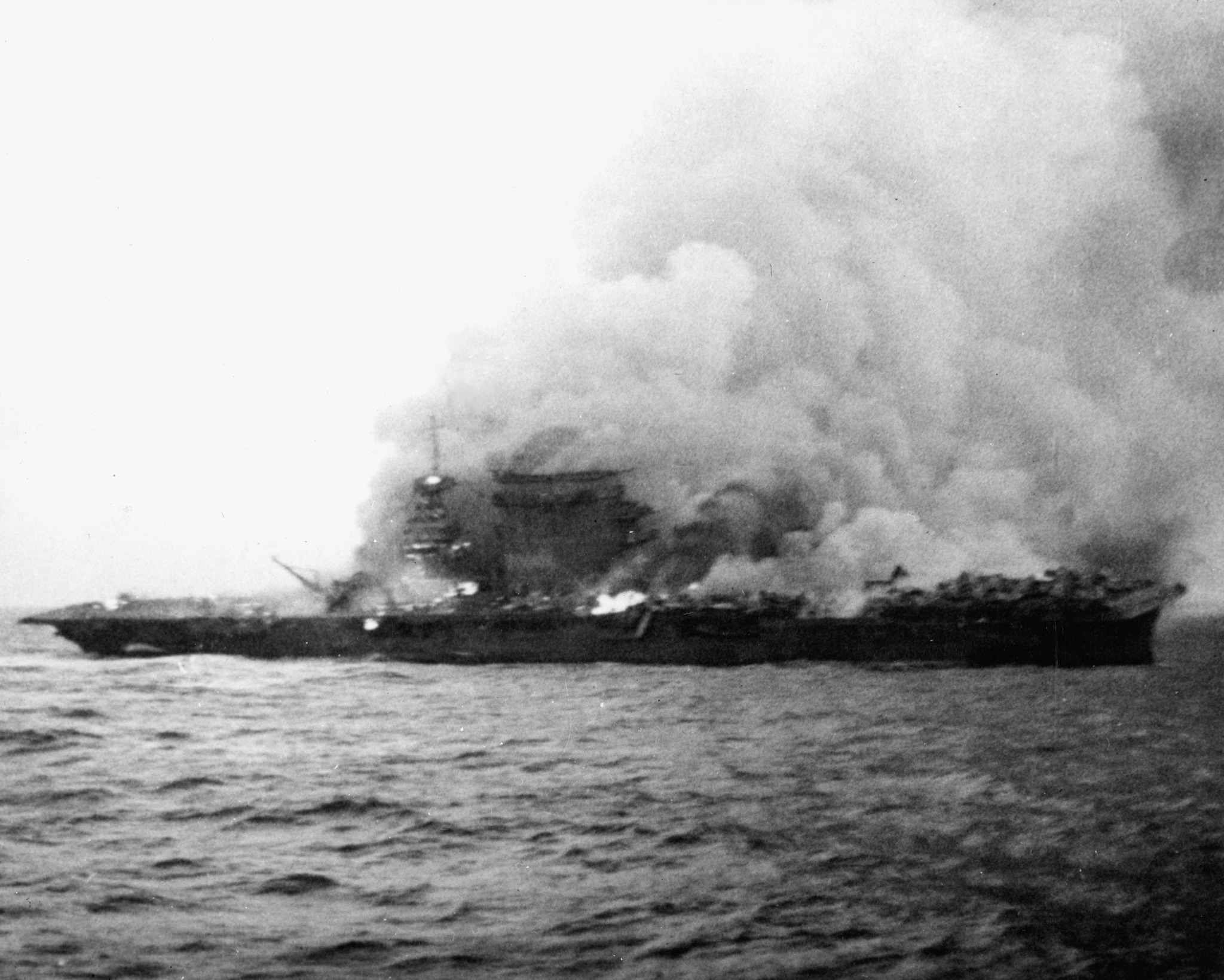 U.S. sailors abandon the aircraft carrier USS Lexington after she