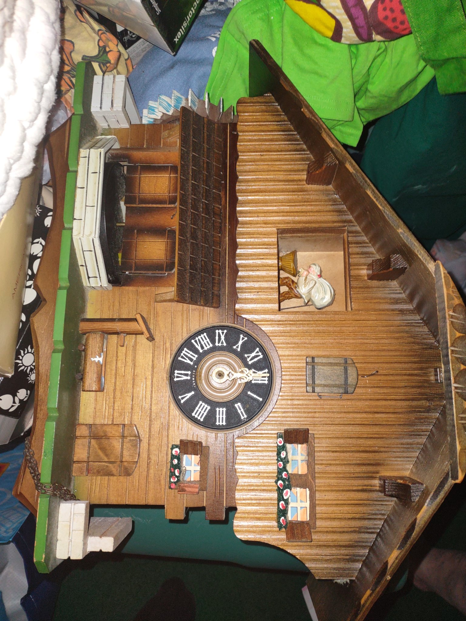 Vintage wooden chalet cuckoo clock has a traditional German house