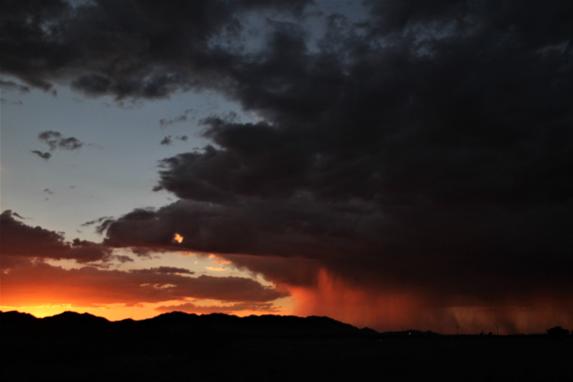 Just a little rain as the sun goes down. Avra Valley, Arizona USA