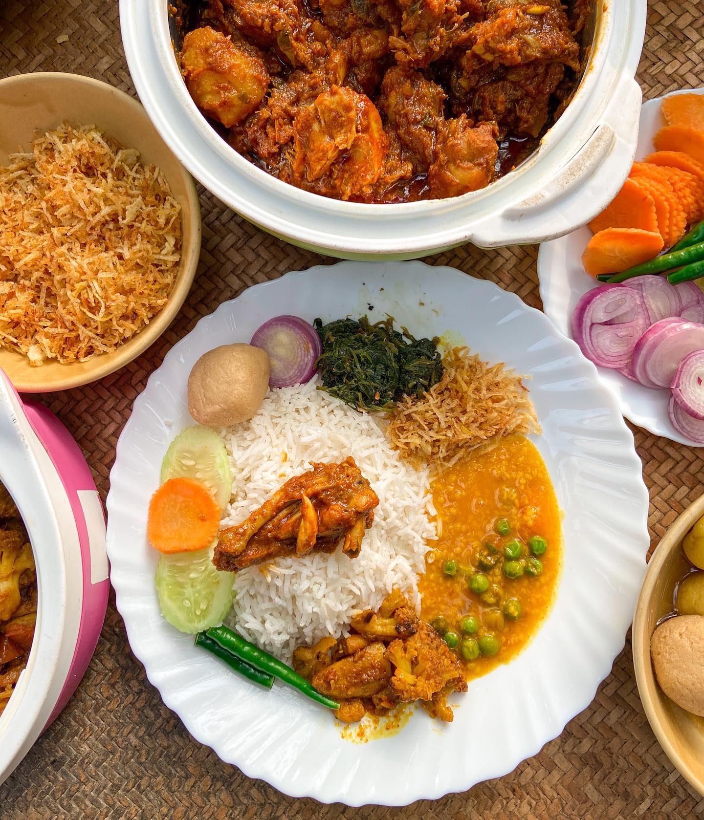 Traditional Bengali thali with chicken kosha and rosogolla
