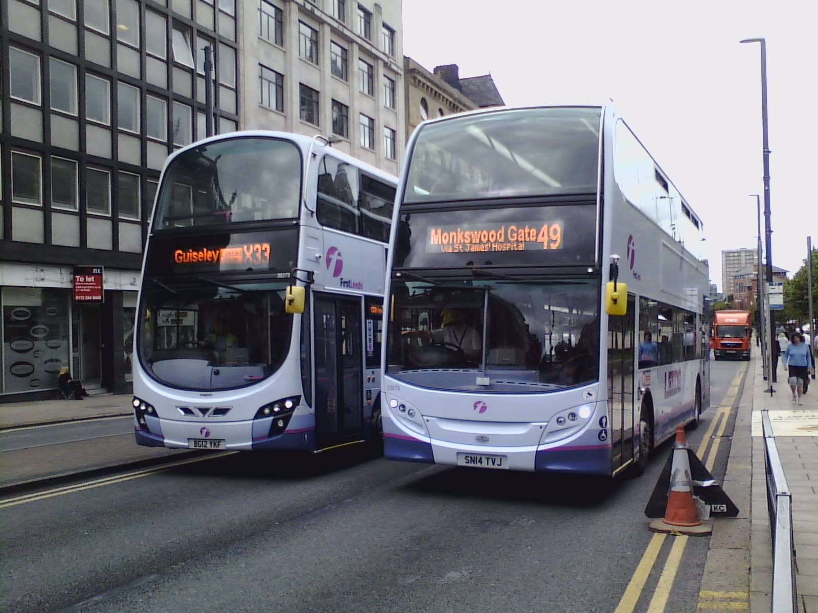 Leeds - Ex-First Games Transport vehicles setting off on The Headrow ...