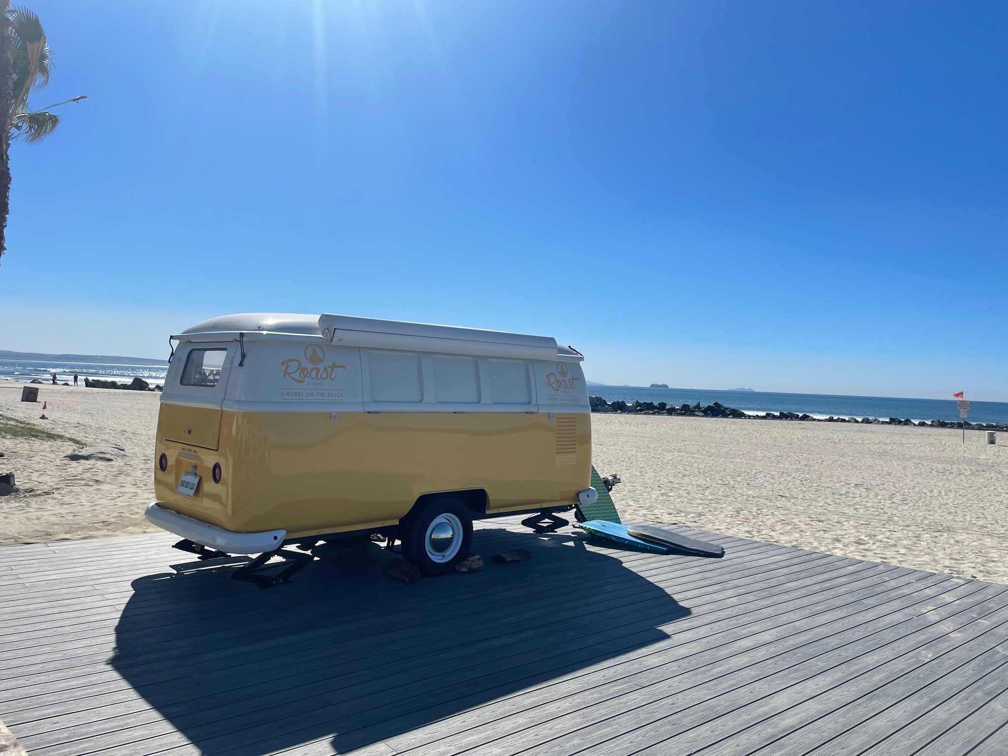 glass made vw bus loaded with happy surfer girls and their surfs 