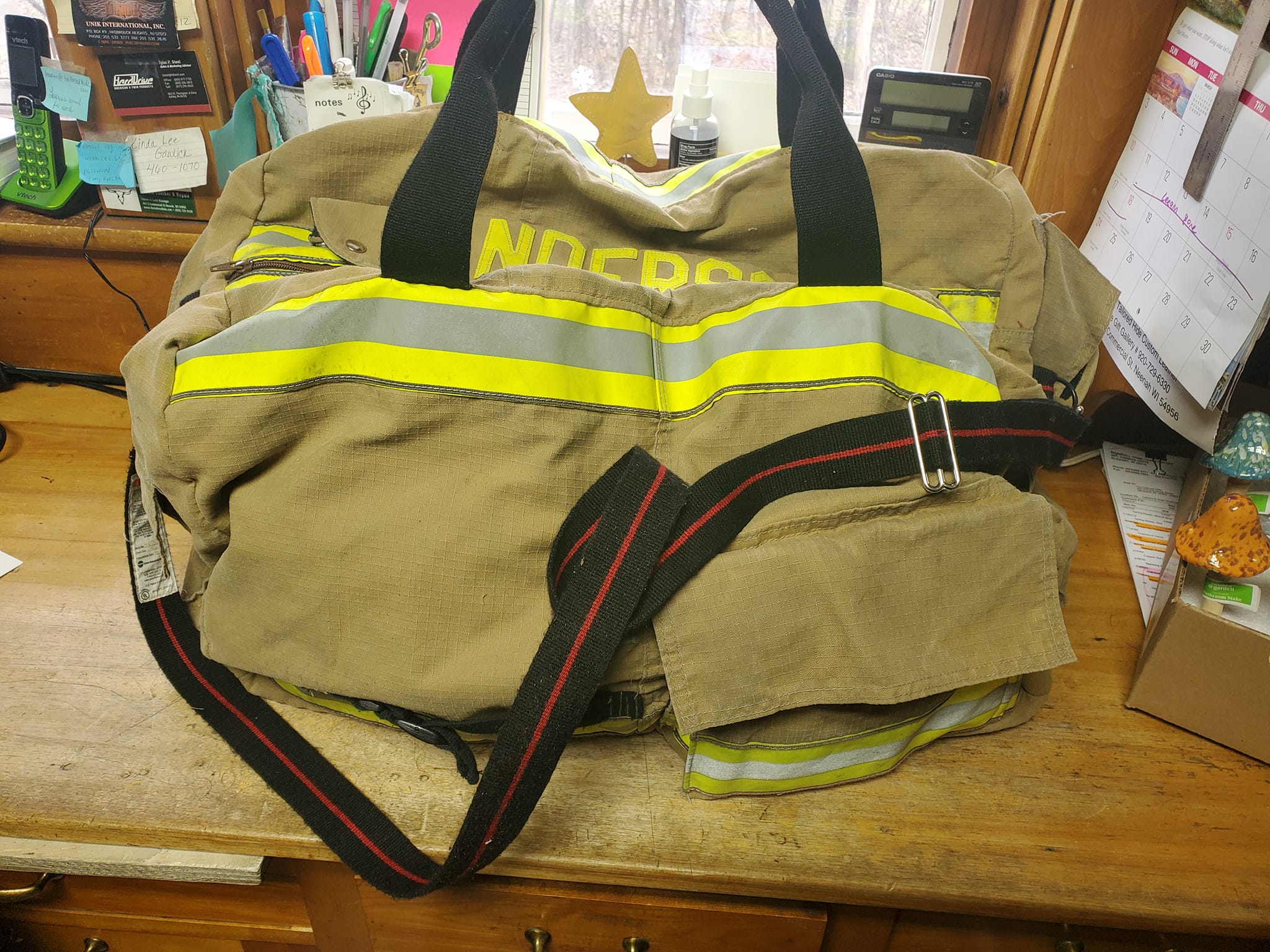 Upcycled fireman jacket with reflective poop bag pouch
